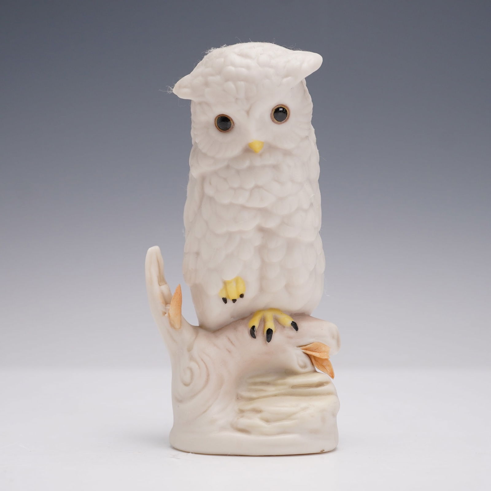 Cybis Porcelain Figurine, Owl: A fine Cybis porcelain figurine depicting an owl perched on a branch, finished in matte white bisque with hand-painted details to the beak, eyes, and talons. The piece bears the Cybis signature and im