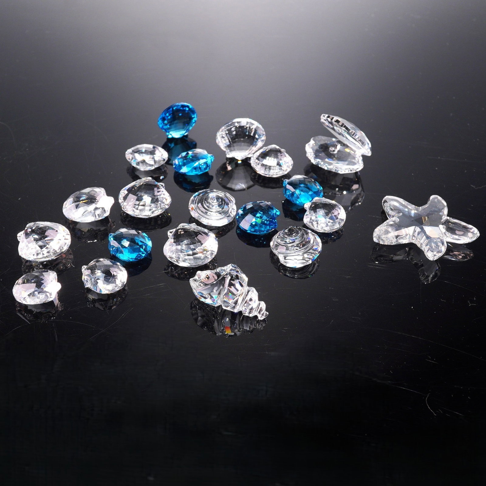 20 pc Swarovski Crystal Figurines, Ocean Theme: This lot features a collection of twenty exquisite Swarovski crystal figurines, all crafted with the brand's signature precision and brilliance. The set includes a variety of ocean-inspired designs su