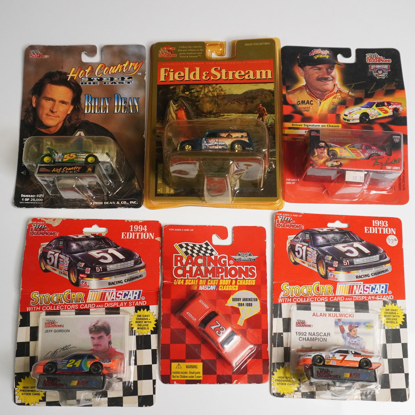 6pc Racing Champions Die Cast Toy Cars: Collection of six Racing Champions die cast toy cars, each presented in its original packaging. Includes a Hot Country Series car featuring Billy Dean (Issue 21, 1 of 25,000), and a Riverside Thriller