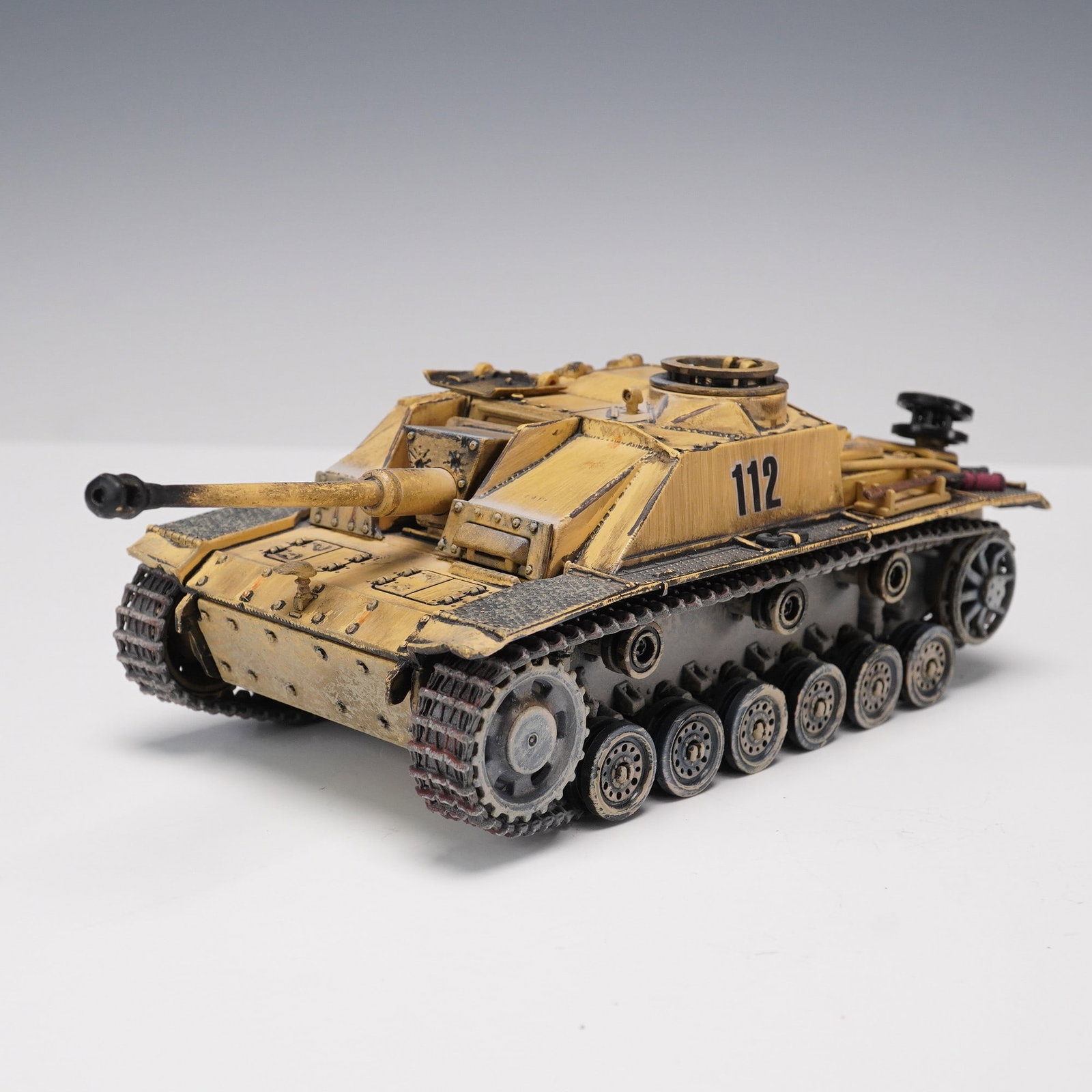 Unimax Forces of Valor 1:32 German Sturmgeschutz III Ausf. G Tank Destroyer: Detailed 1:32 scale German Sturmgeschutz III Ausf. G (StuG III G) tank destroyer produced by Unimax as part of the Forces of Valor series. Marked "112" with a realistic weathered desert yellow finish,