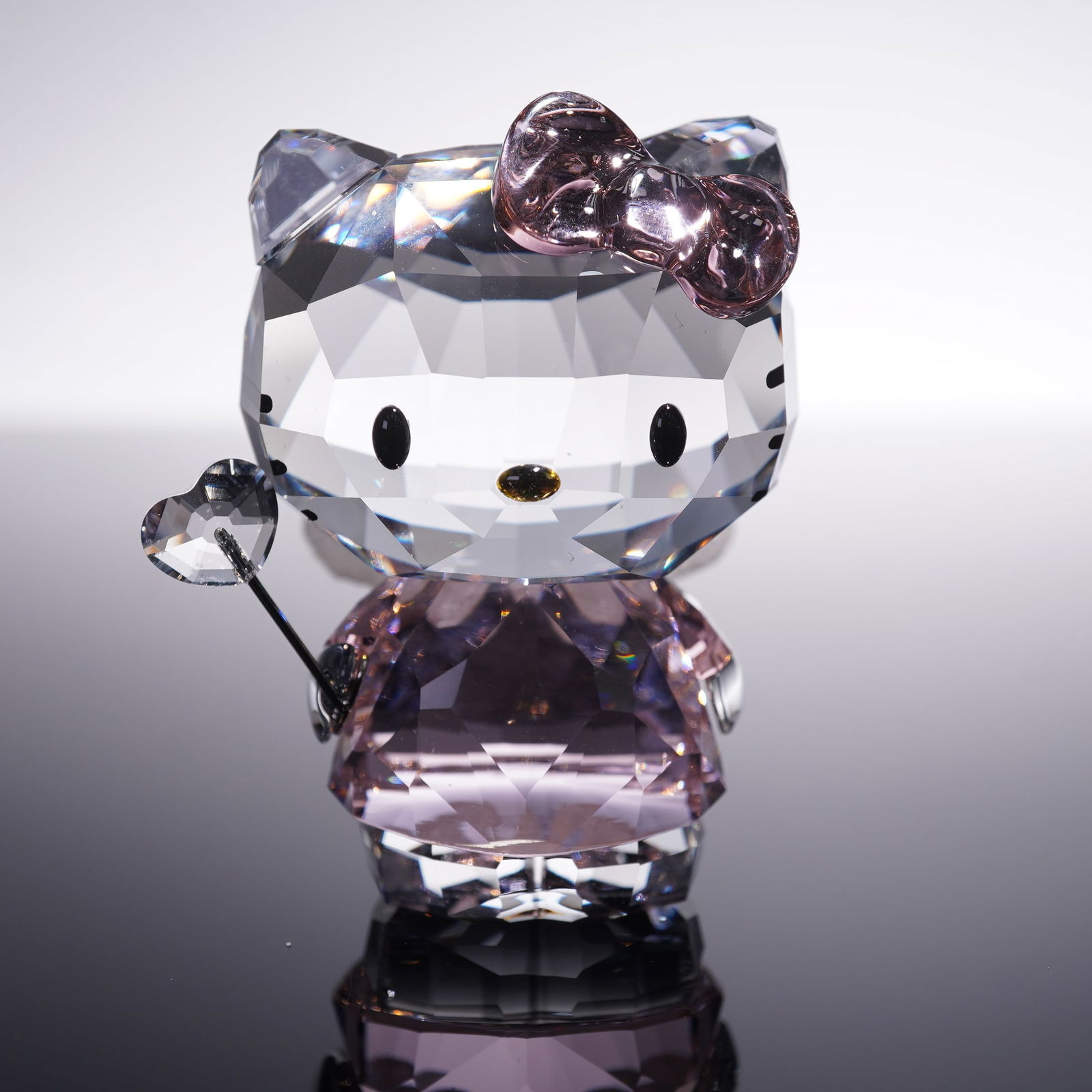 Swarovski Crystal Figurine, Hello Kitty: A cute and whimsical crystal figure depicting the beloved Hello Kitty character in angelic form. With her magic wand, Hello Kitty will enchant you. Sparkling in clear crystal with a Tender Pink crysta
