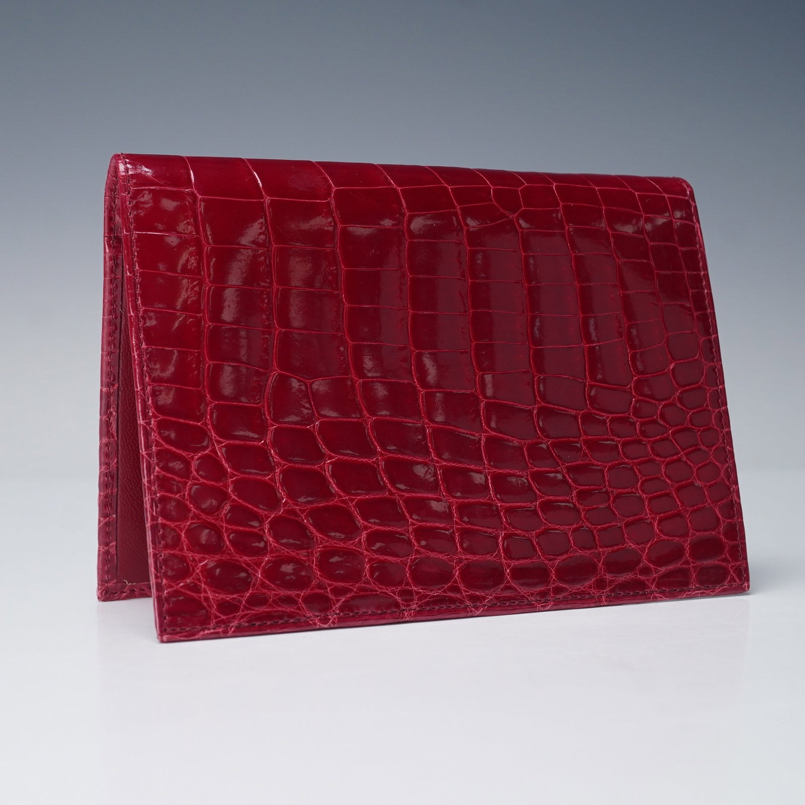 Tiffany & Co. Red Crocodile Leather Passport Cover with Dust Bag: A Tiffany & Co. red crocodile-embossed leather passport cover/travel wallet, crafted with a glossy finish and detailed texture. The passport cover/travel wallet opens to reveal multiple card slots and
