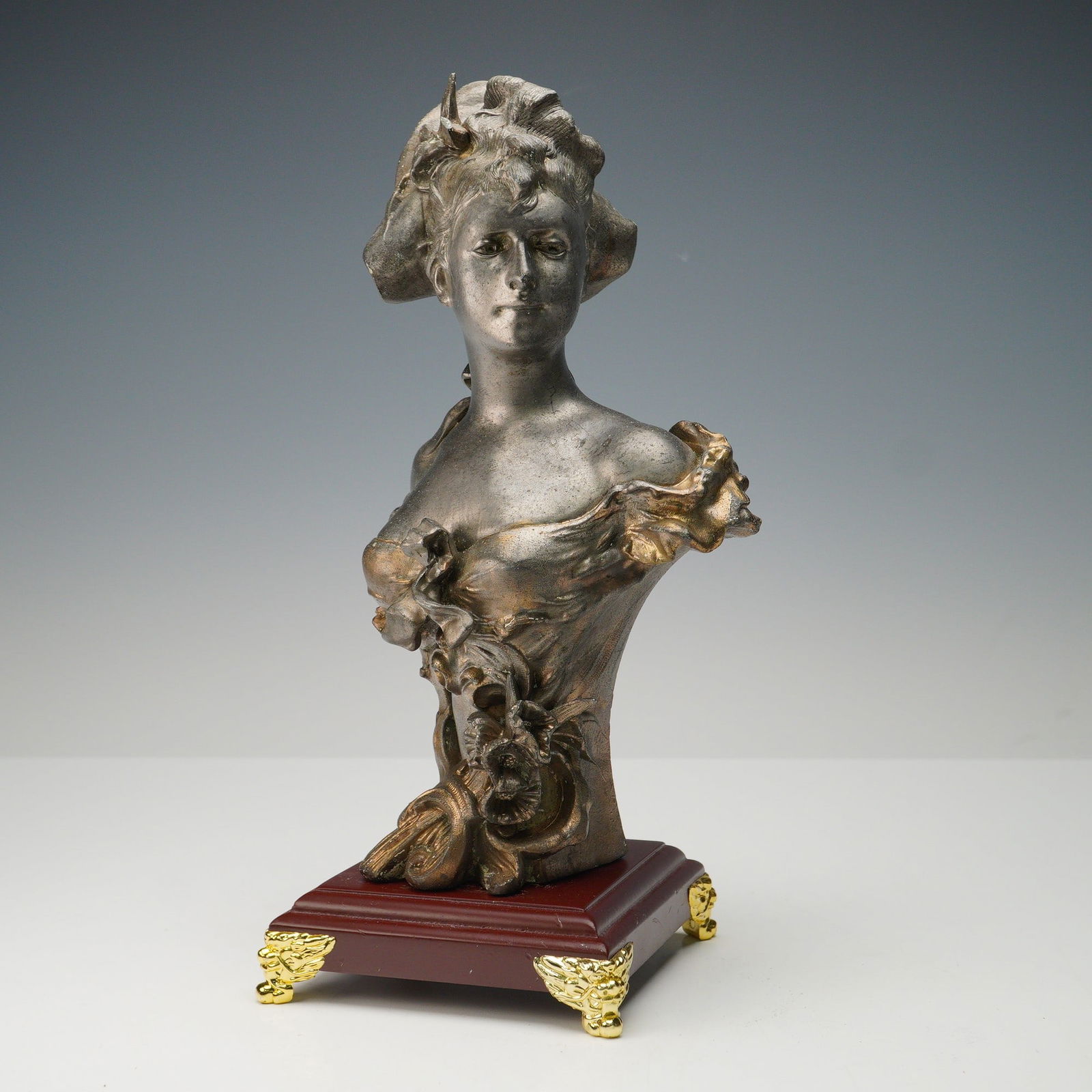 Alfred Jean Foretay (Aft.) Bronze Bust of a Maiden: Bronze sculpture of a maiden in the Art Nouveau style, after the work of Swiss artist Alfred Jean Foretay. The figure is depicted in a flowing off-the-shoulder gown adorned with floral motifs, her hai