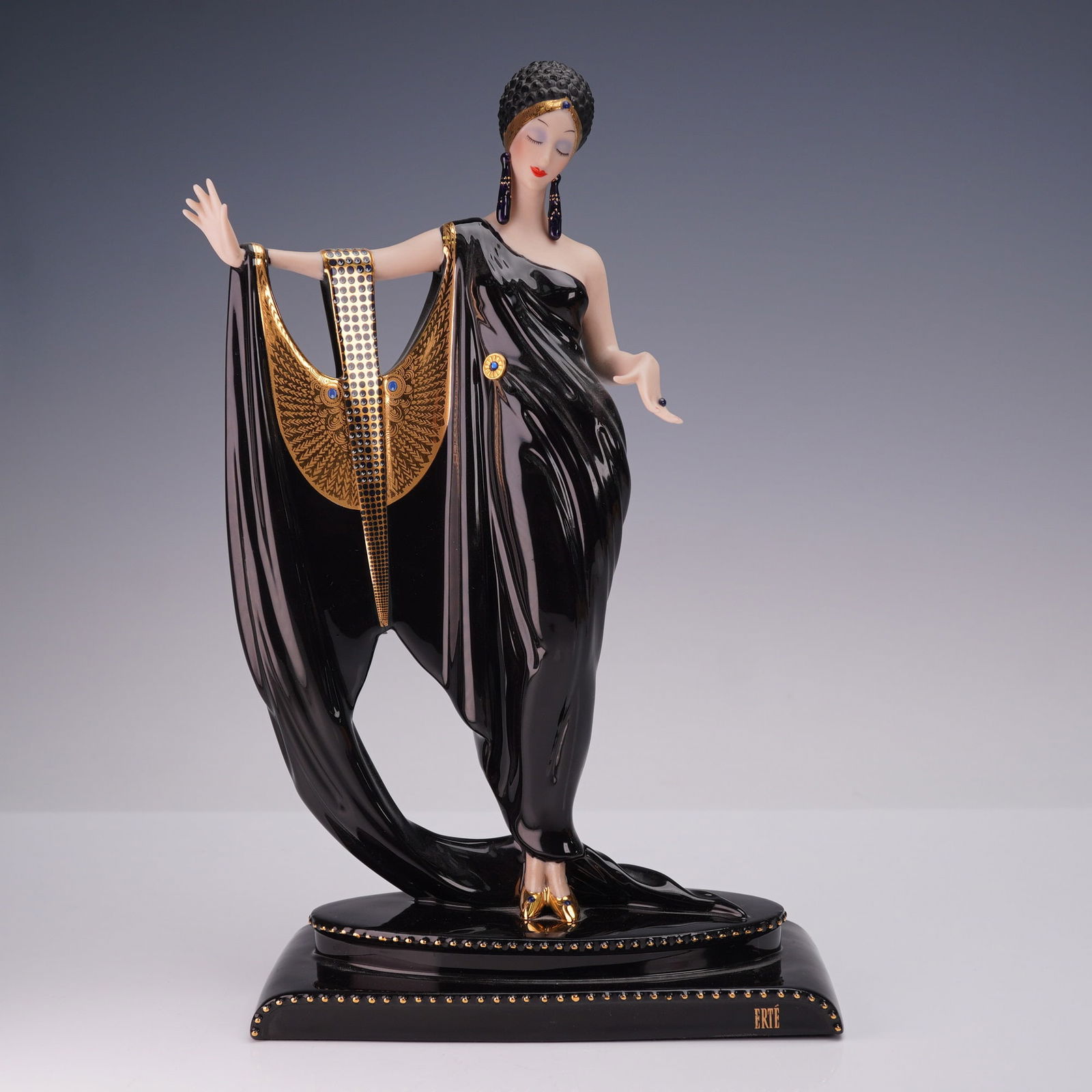 Franklin Mint House of Erte Figurine, Glamour: House of Erte fine porcelain figurine titled Glamour, a limited edition piece numbered 0932, crafted in Malaysia and hand painted. This elegant Art Deco inspired figure depicts a stylized woman in a f