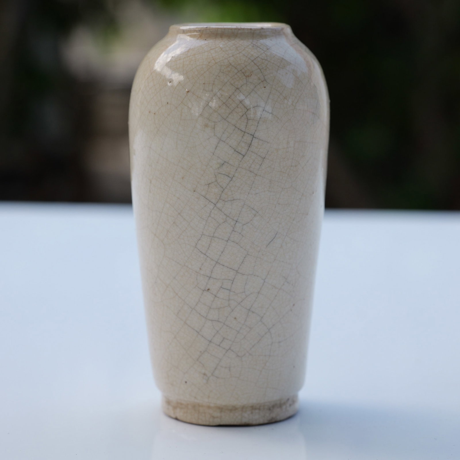 Chinese Ge Ware Mini Vase: Featuring a narrow body with gently sloping shoulders and a short neck with a rounded lip. The surface is finished in a pale, translucent glaze exhibiting an extensive and well-defined crackle pattern