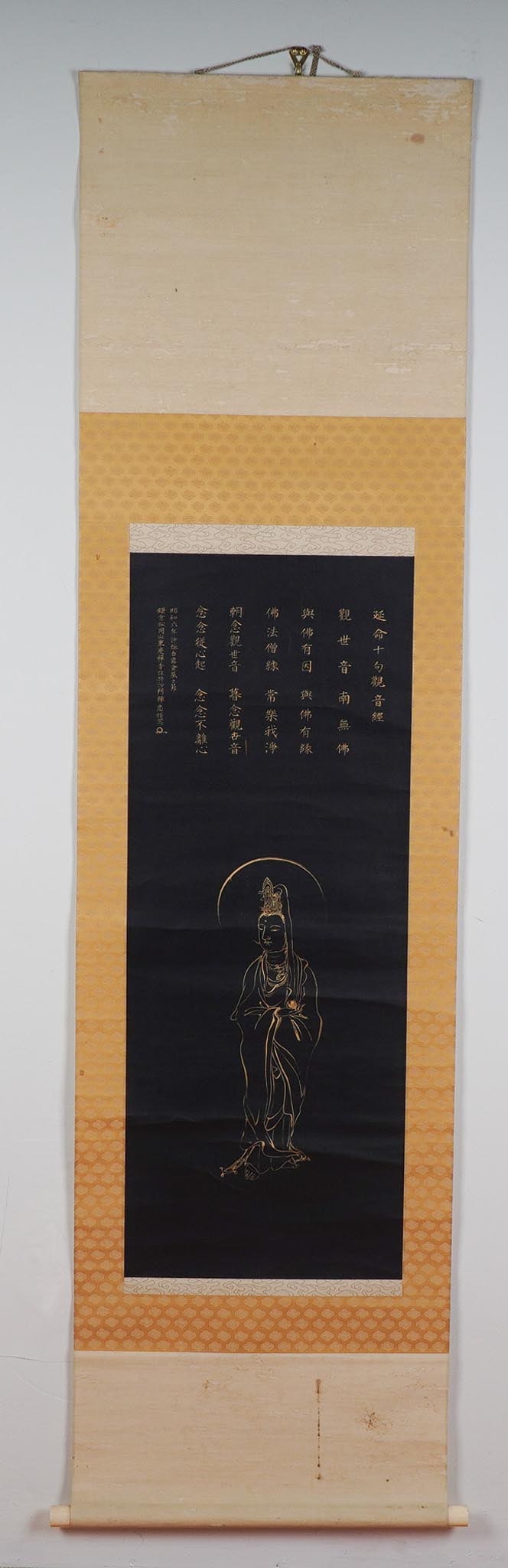 Japanese Hanging Scroll Painting, Kannon: This hanging scroll painting, created using gold ink on black paper, features Kannon, the bodhisattva of compassion. The figure stands gracefully, adorned in an elaborate headdress and flowing robes, 