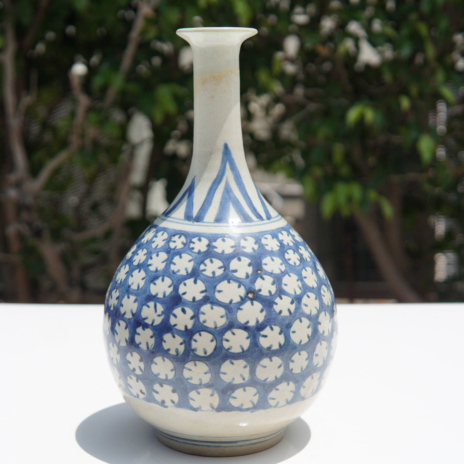 Japanese Edo Period Hizen Ware Vase: Japanese porcelain vase attributed to the Hizen ware tradition, also referred to as Arita ware, originating from the Edo period (1603-1868). This bottle-shaped vessel features a long, slender neck wit