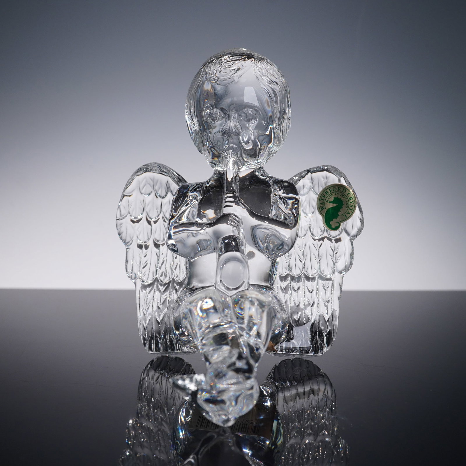 Waterford Crystal Figurine, Sitting Cherub: A Waterford Crystal figurine depicting a sitting cherub playing a flute. Beautifully detailed with finely cut wings and clear sculpted features, retaining the original Waterford Crystal green and gold