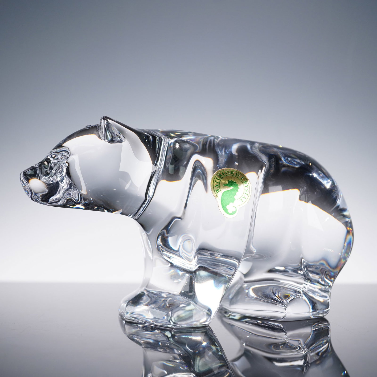 Waterford Crystal Figurine, Bear: Clear Waterford Crystal figurine in the form of a standing bear, finely sculpted with smooth contours and a polished finish. The piece retains its original green and gold seahorse Waterford label and 