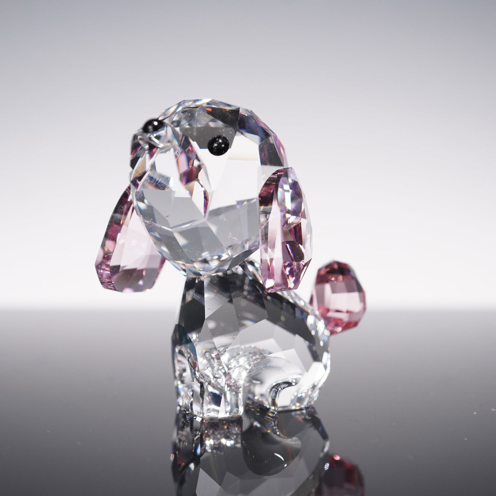 Swarovski Crystal Figurine, Rosie The Poodle Puppy: This sparkling Swarovski crystal figurine features Rosie the Poodle Puppy from the Lovlot Puppies collection. Crafted with clear crystal and accented with soft pink crystal ears and tail, the piece is