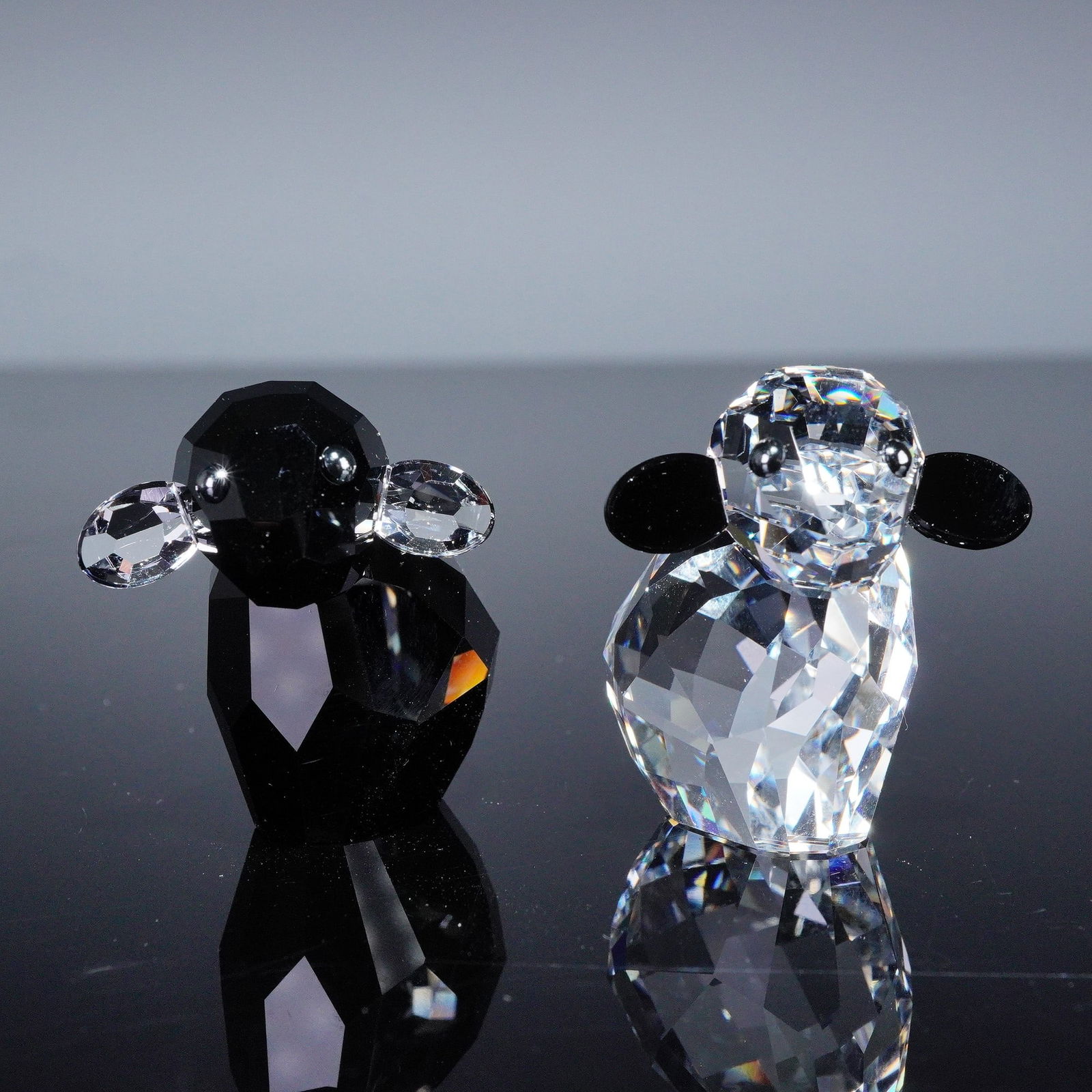 2pc Swarovski Crystal Lovlots Pioneers Figurines, Ebony and Ivory: Enchanting couple sparkling in contrasting black and white crystal tones. Both accented with contrasting glossy black ears and finely detailed eyes. Swarovski backstamp. This item has its original box