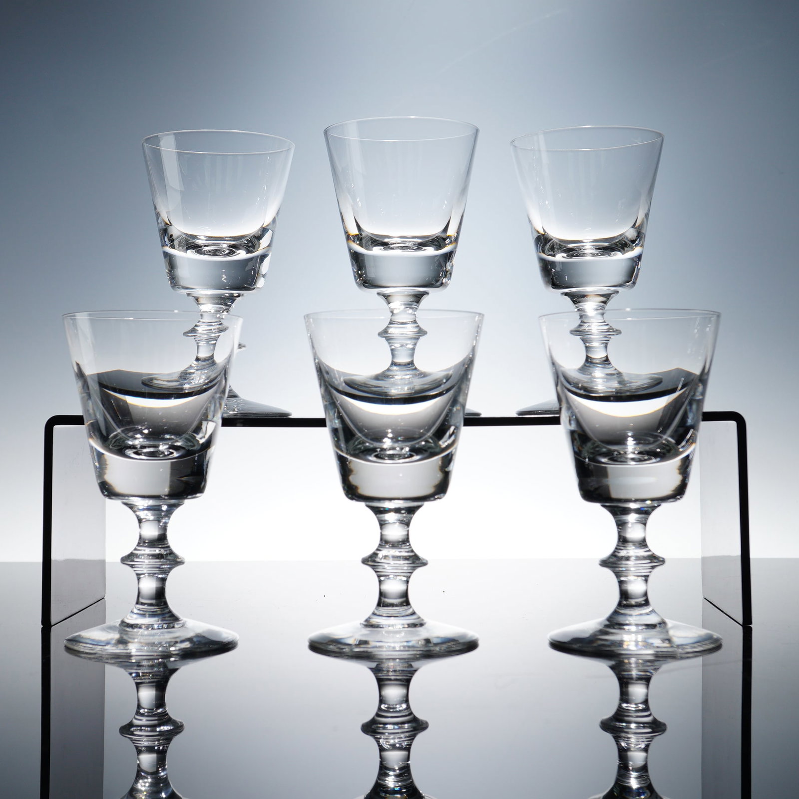 6pc Val St Lambert Crystal White Wine Glasses, State Plain: A fine set of six Val St Lambert State Plain crystal white wine glasses. These stems feature tapering bowls and distinctive stepped stems, showcasing the clarity and balance for which the Belgian glas