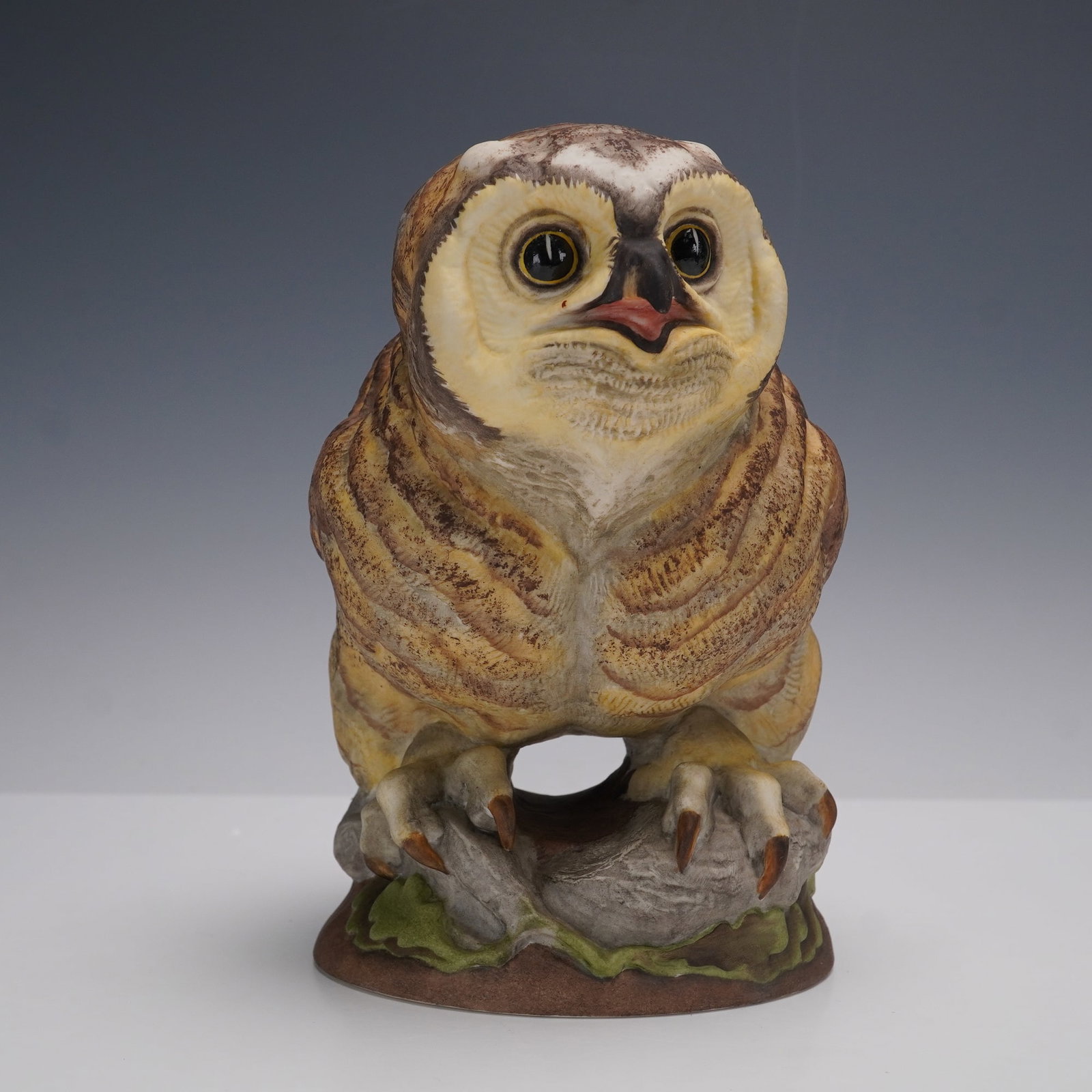 Boehm Porcelain Figurine, Fledgling Great Horned Owl 479: A lovely hand painted owl figurine designed in a limited edition. This delicacy is depicted as an owl with big round glossy eyes perched on a branch and leaves. Painted in naturalistic detailed. No. 4