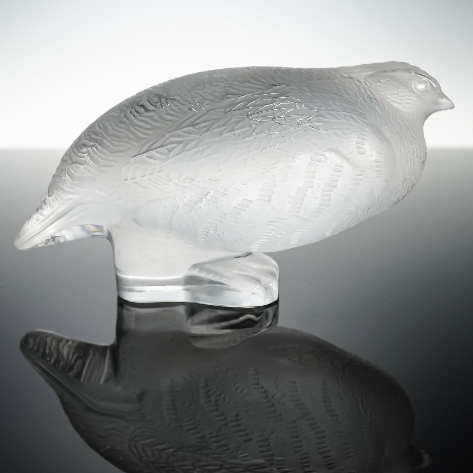 Lalique Crystal Figurine, Perdrix Partridge: A finely crafted Lalique crystal figurine depicting a partridge, titled Perdrix. Rendered in clear and frosted crystal, the piece highlights detailed feathering and naturalistic form. Signed Lalique F