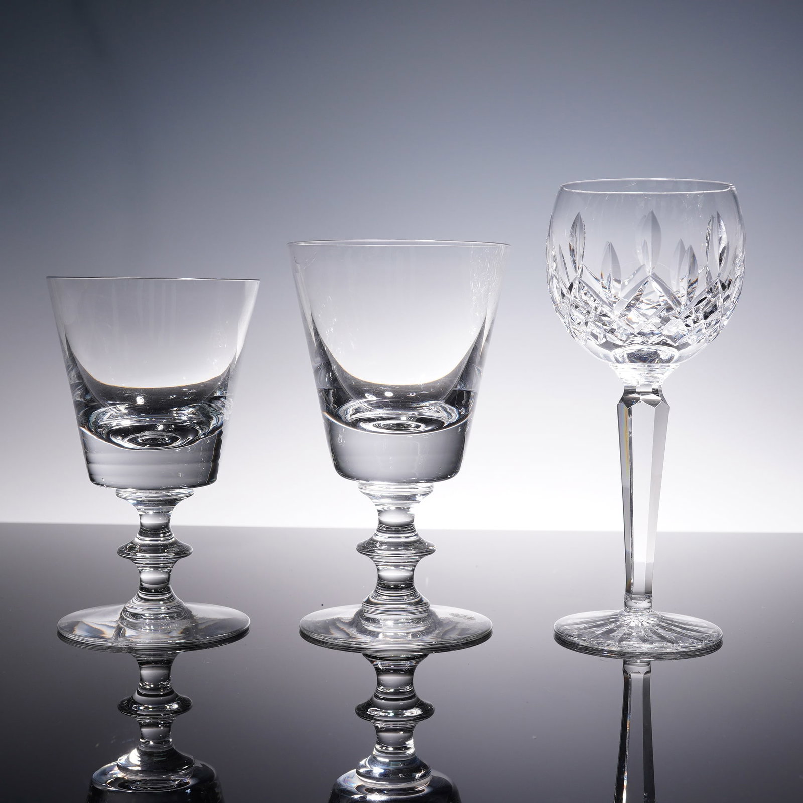 3pc Waterford and Val St Lambert Crystal Water and Wine Glasses: A set of three crystal stemware pieces including two Val St Lambert water glass and white wine glass with etched base marks and one Waterford cut crystal wine glass with faceted stem and acid-etched s