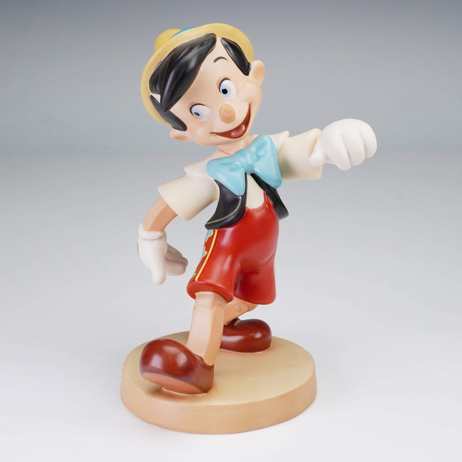 Walt Disney Classics Figurine, Pinocchio, Look Out, World!: This charming Walt Disney Classics Collection figurine, titled "Look Out, World!", features the beloved character Pinocchio in a joyful, animated pose, capturing his wide-eyed innocence and sense of w