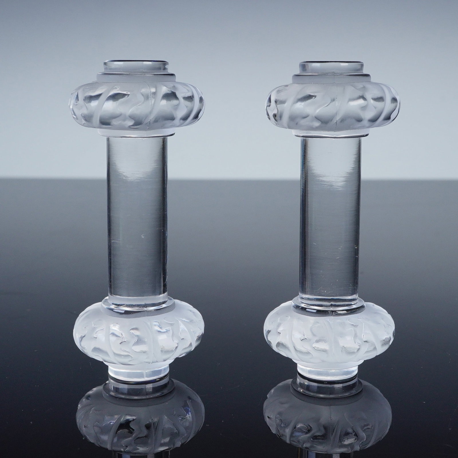 Pair of Lalique Crystal Knife Rests, Saint Hubert Pattern: Pair of Lalique crystal knife rests in the Saint Hubert pattern. Each rest features a cylindrical clear crystal stem with frosted ends molded in relief with stylized leaf motifs. Both are signed Laliq