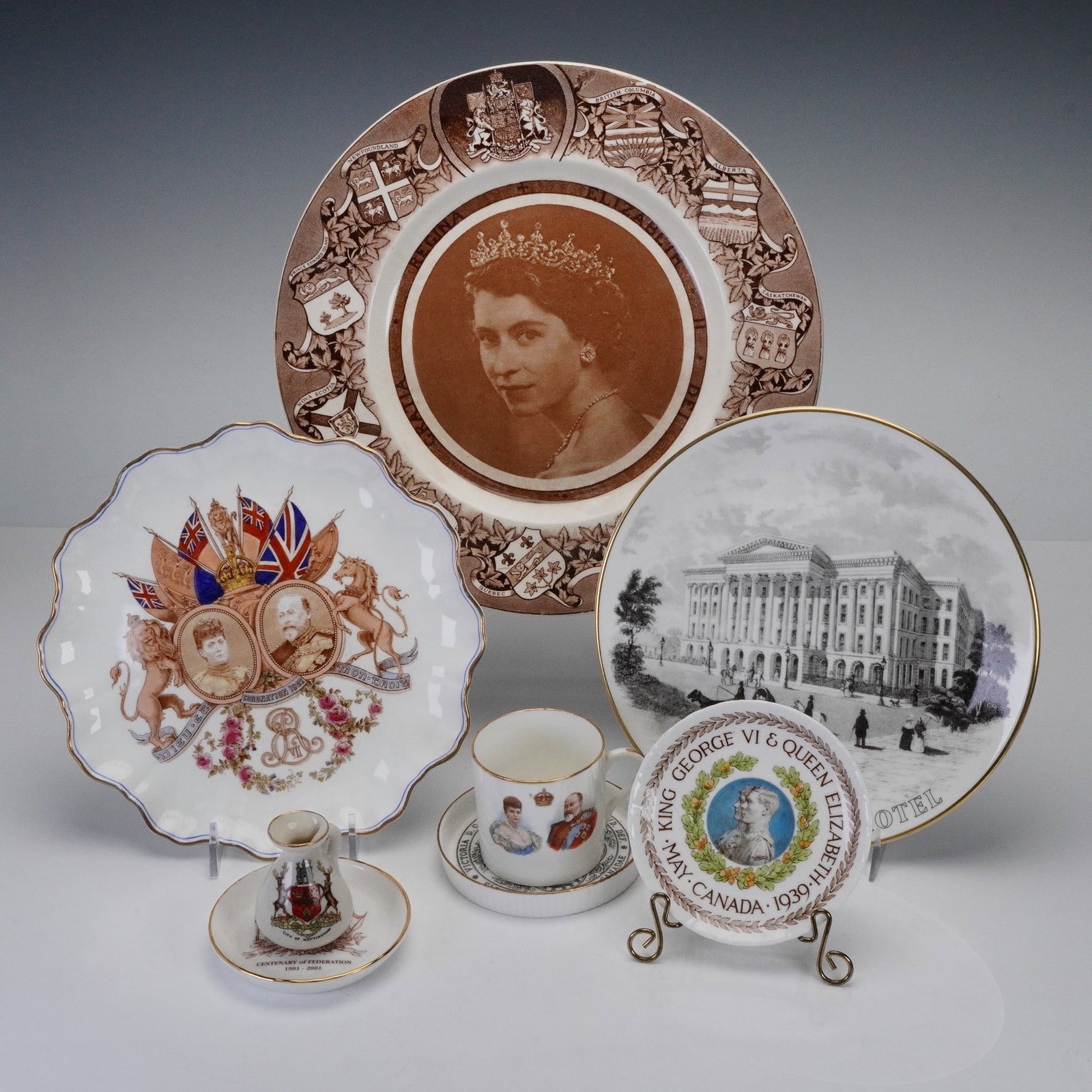 8pc Royal Commemorative Porcelain Collection by Royal Doulton and Others: This diverse group of commemorative wares celebrates significant moments in British royal history and heritage, produced by renowned makers including Royal Doulton, Staffordshire, and Venetia China. T
