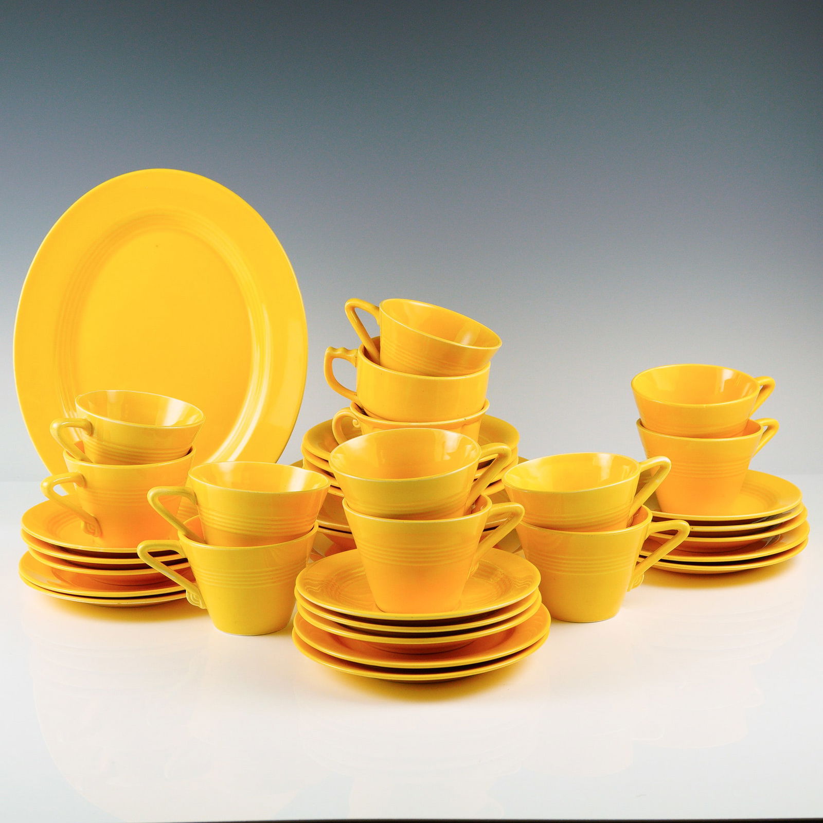 36pc Vintage Ceramic Dinnerware, Yellow: This vibrant 36-piece dinnerware set showcases a bold and cheerful yellow glaze, perfect for adding a pop of color to any table setting. The collection includes a dinner plate, 6 salad plates, 9 sauce