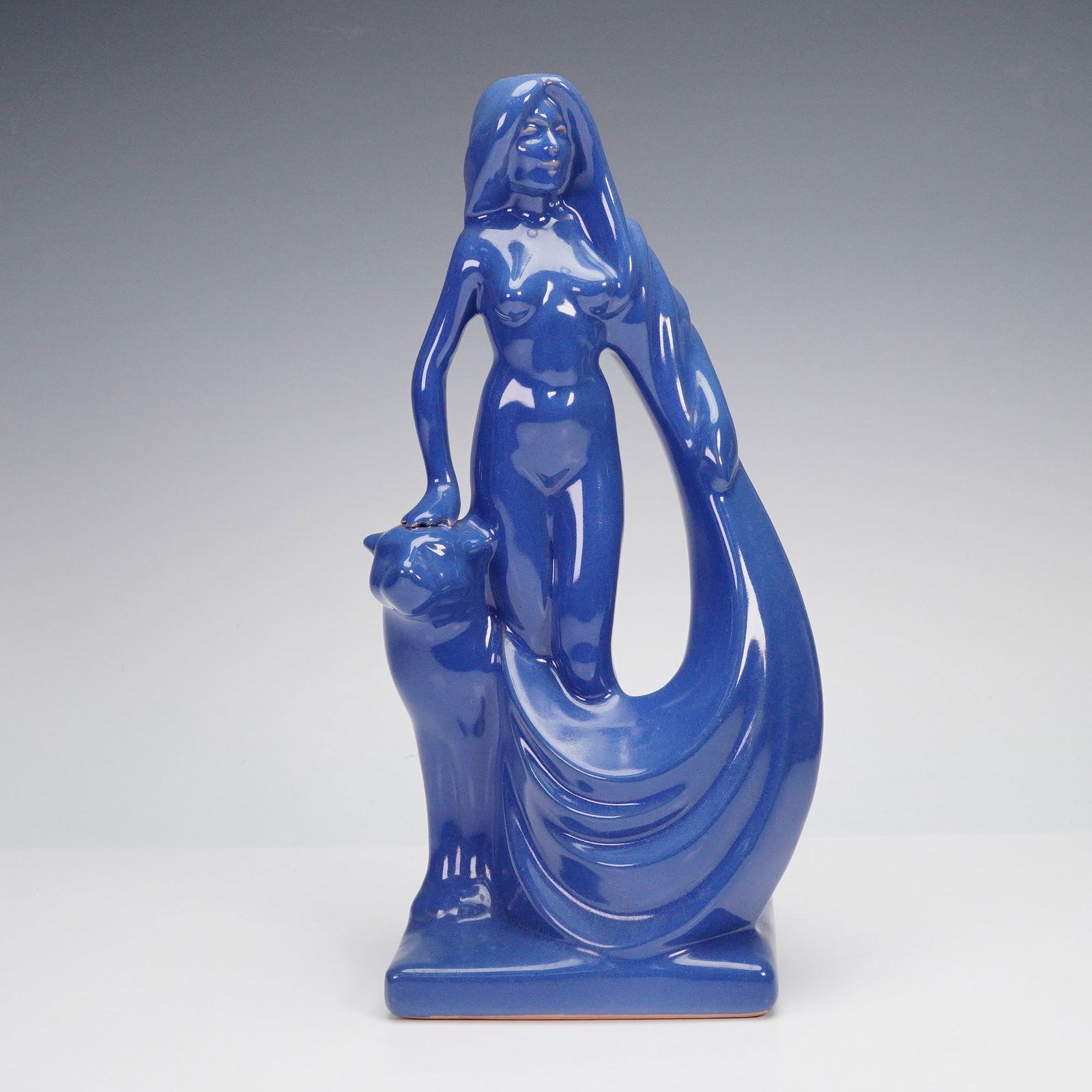 Frankoma Pottery Woman with Panther Figurine: A bold Frankoma Pottery figurine, model 531, designed by artist Gerald Smith in 1952, depicting a nude female figure with flowing drapery and long hair, posed with one hand resting on a stylized panth