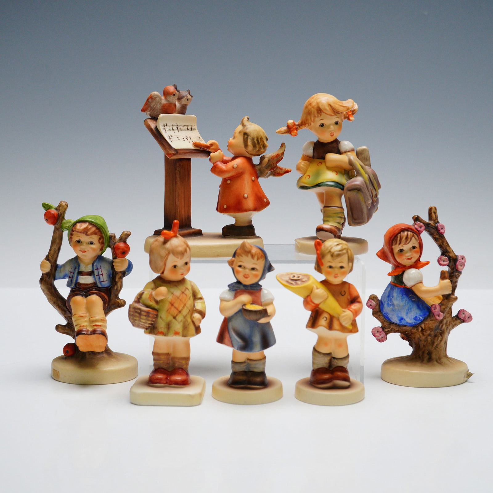 7pc Goebel Hummel Figurines: Collection including "Bird Duet" (HUM169), "School's Out" (HUM538), "Apple Tree Boy" (HUM142 3/0), "I Brought You A Gift" (HUM479), "From Me to You" (HUM629), "A Sweet Offering" (HUM549 3/0), and "App