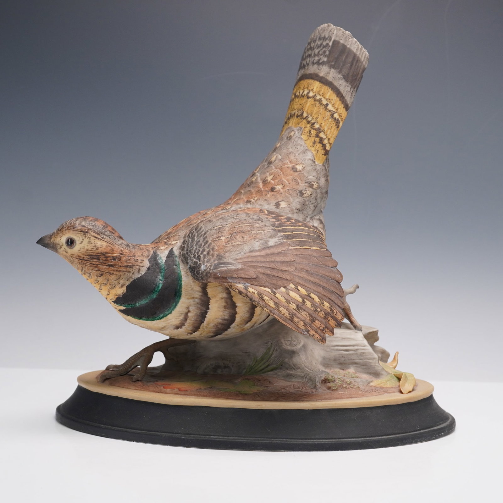 Boehm Porcelain Figurine, Ruffed Grouse: A charming porcelain figurine depicting a ruffed grouse in a poised stance with wings slightly extended. The bird is meticulously painted in shades of brown, tan, and cream, accented with yellow and b