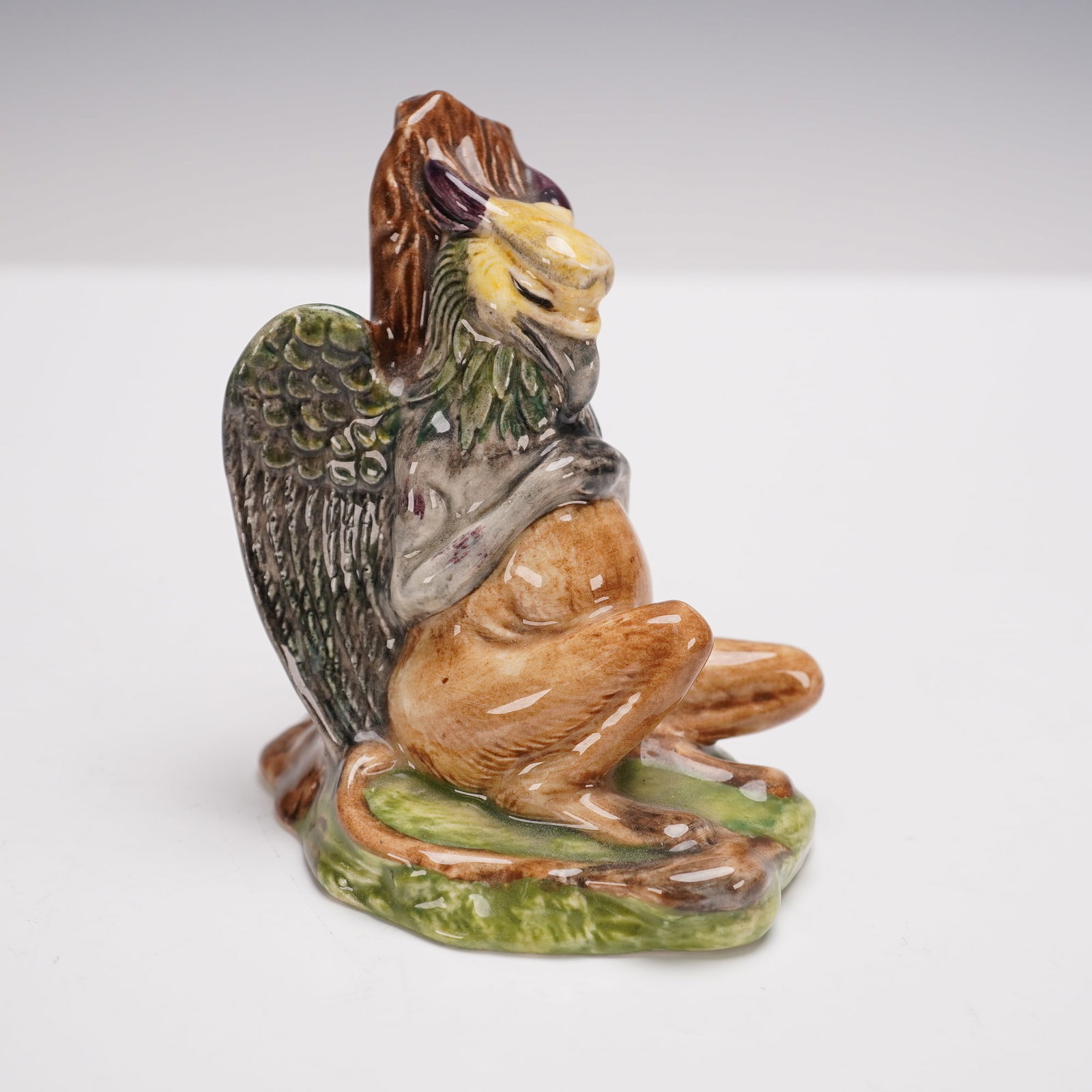 Beswick Alice in Wonderland Series Gryphon Figurine: Beswick porcelain figurine titled Gryphon from the Alice in Wonderland Series, made in England. Marked on the base Royal Doulton Tableware Ltd. 1974. The figure depicts the mythical Gryphon seated aga