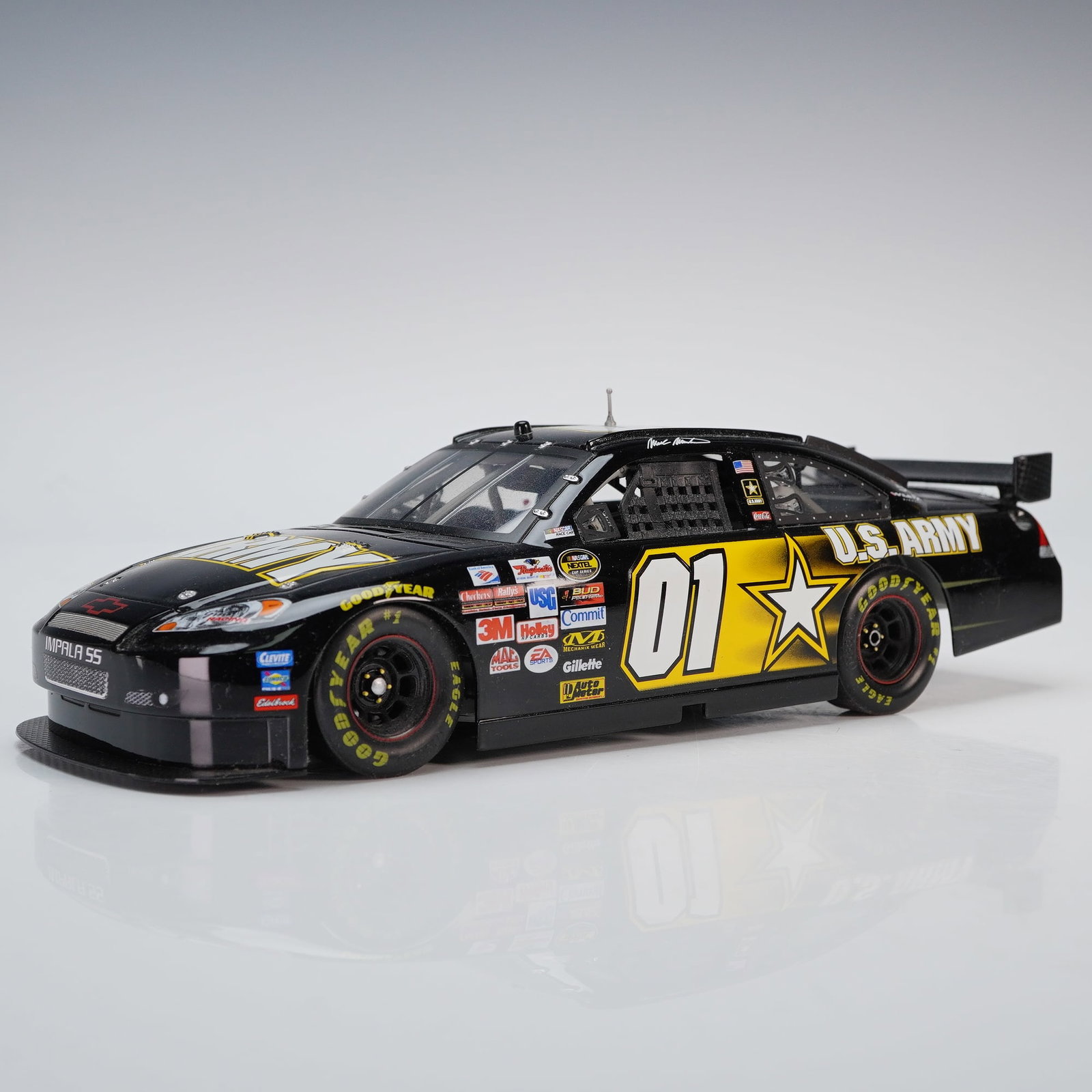 Checkered Flag Sports 2007 Chevrolet Impala Mark Martin 01 U.S Army Toy Car: This Checkered Flag Sports diecast showcases Mark Martins 2007 Chevrolet Impala in bold black with striking gold graphics and sponsor logos. The detailed model features authentic race decals, Goodyear