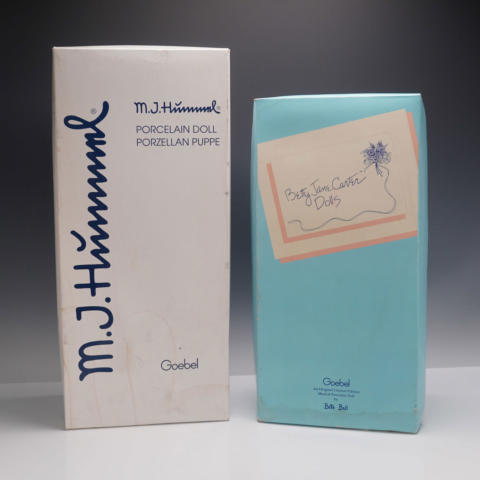 2pc Goebel Hummel School Girl 521 & Betty Jane Carter Monkey Porcelain Doll: Collectible porcelain dolls including Goebel's M.J. Hummel School Girl (model 521), complete with original outfit, basket accessory, and certificate of authenticity. Produced by Goebel as part of thei