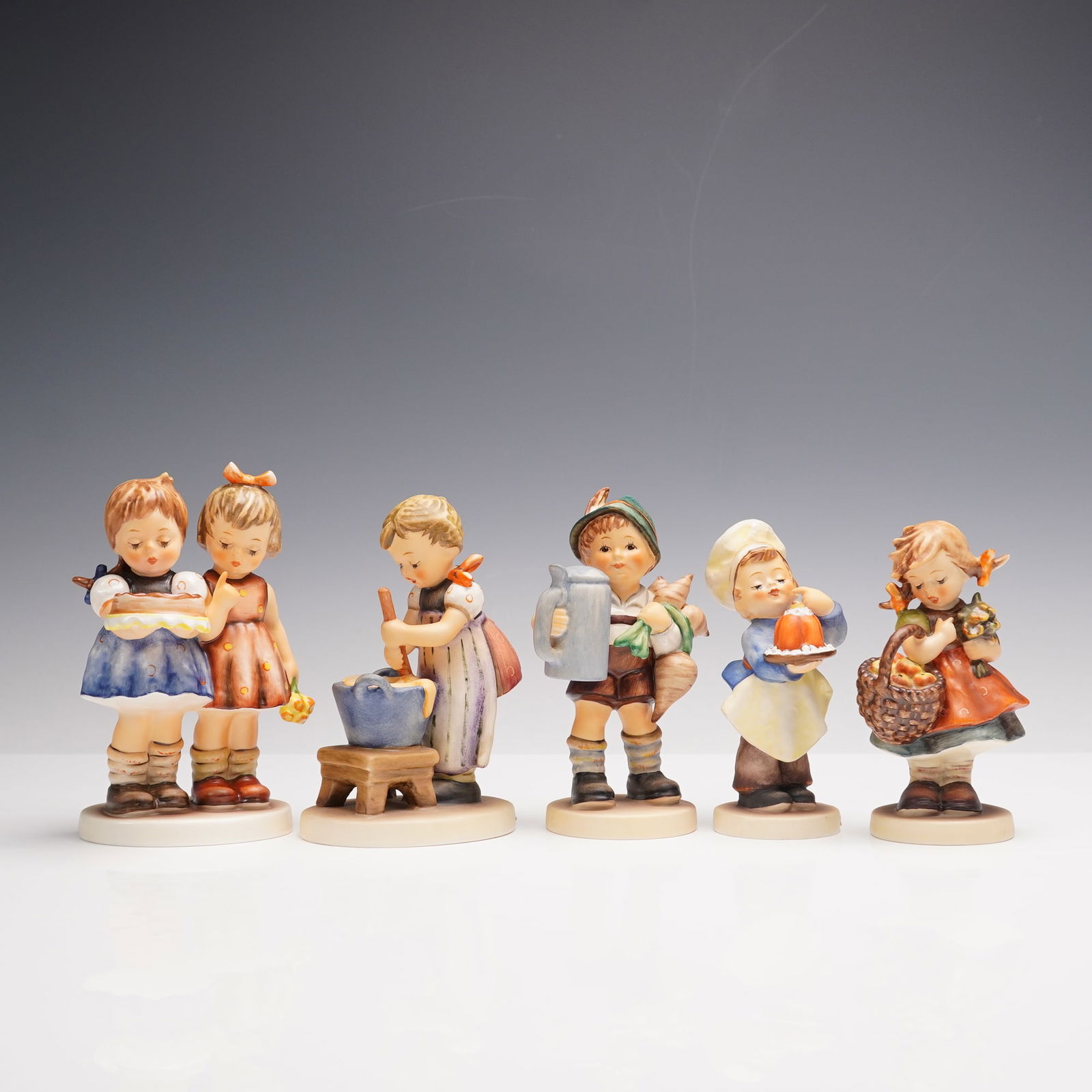 5pc Goebel Hummel Figurines: This delightful collection of five Goebel Hummel figurines showcases charming scenes of children in everyday moments. Baking Day features a young girl mixing ingredients in a bowl with focus and care.