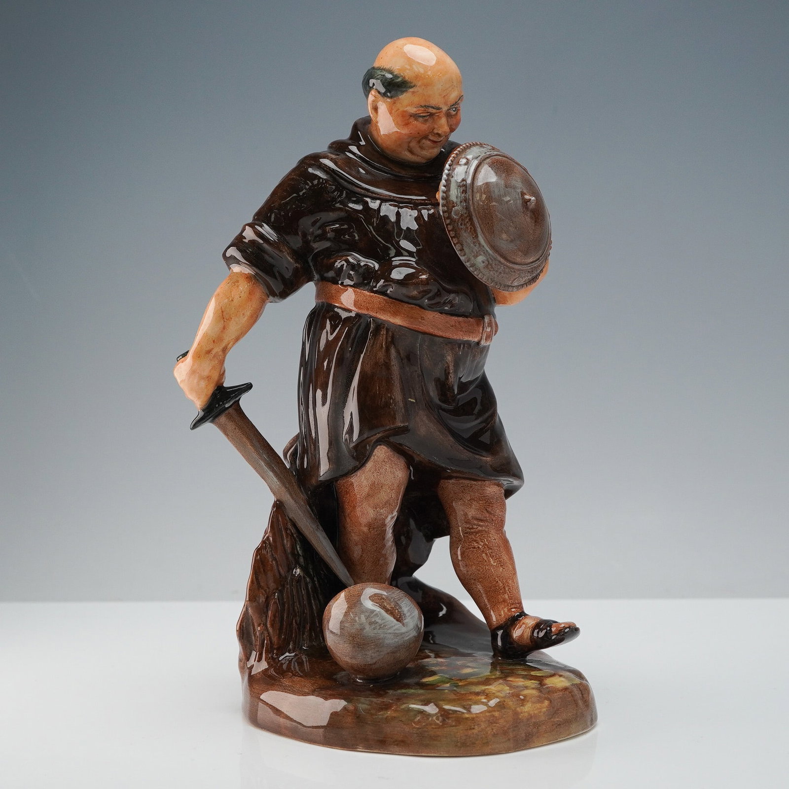 Royal Doulton Figurine, Friar Tuck HN2143: Royal Doulton bone china figurine titled Friar Tuck HN2143, modeled after the jovial companion of Robin Hood. Designed with characteristic humor and attention to detail, the figurine depicts Friar Tuc