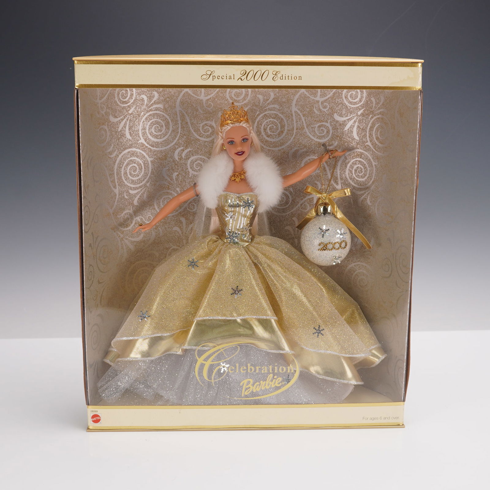 Mattel Celebration Barbie Special 2000 Edition w/ Ornament: A dazzling Mattel Celebration Barbie from the Special 2000 Edition, presented in her original unopened box. This collectible marks the first in a new series of holiday dolls, embodying the spirit of t