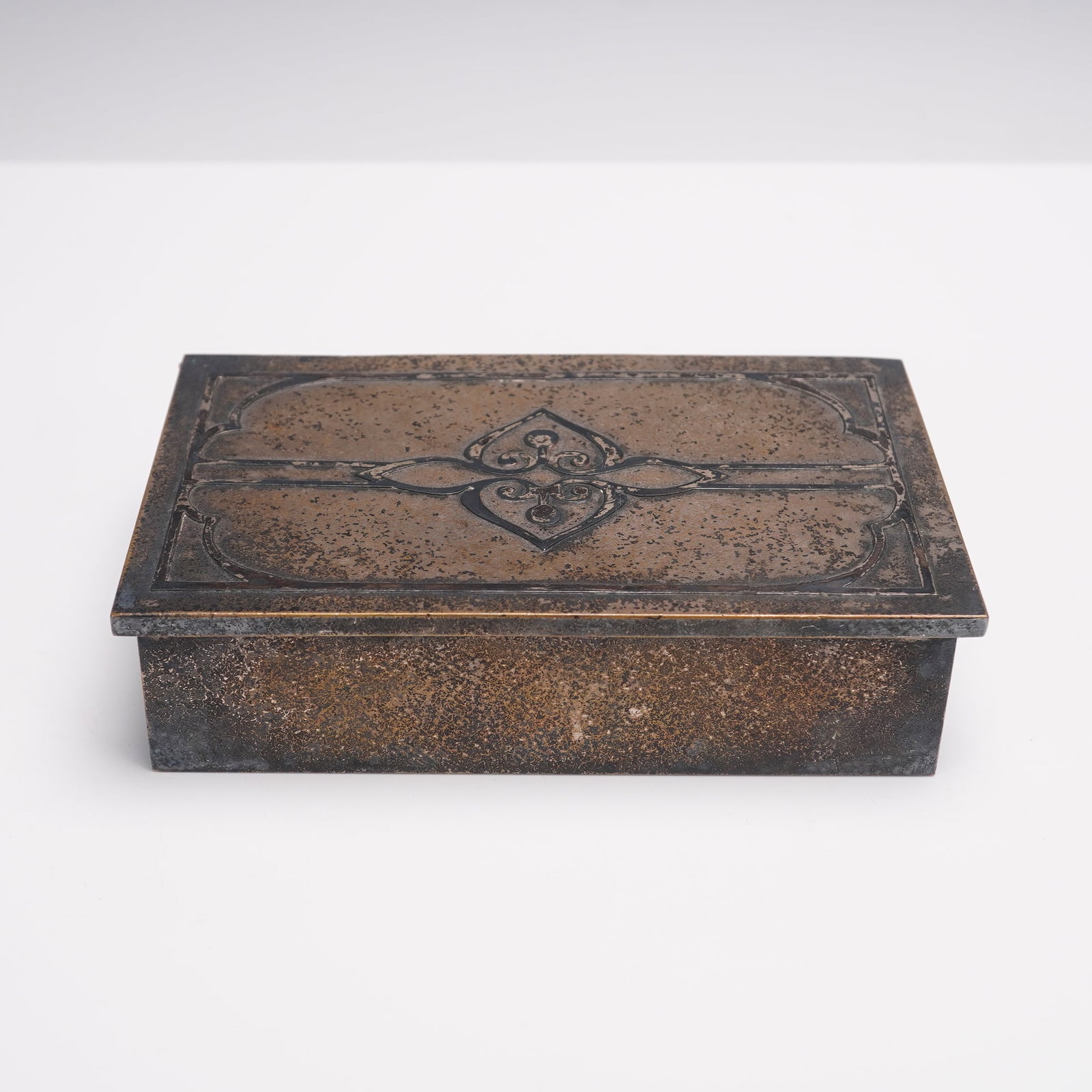 Silver Crest Smaco Sterling Decorated Bronze Box: Early 20th century rectangular bronze box produced by the Smith Metal Arts Company under the Silver Crest line, featuring a hinged lid with embossed geometric and foliate decoration. The interior reta