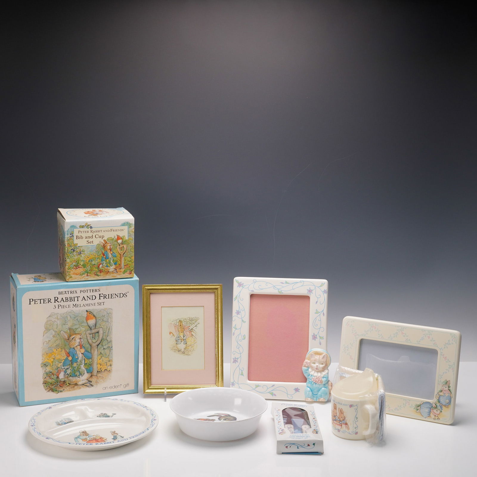 5pc Beatrix Potters Tableware, Bib & Cup Set, Picture and Picture Frames: Charming collection of Beatrix Potter Peter Rabbit and Friends items, including two boxed sets: a 3-piece melamine dining set with plate, bowl, and mug, and a boxed bib and cup set. Also included are