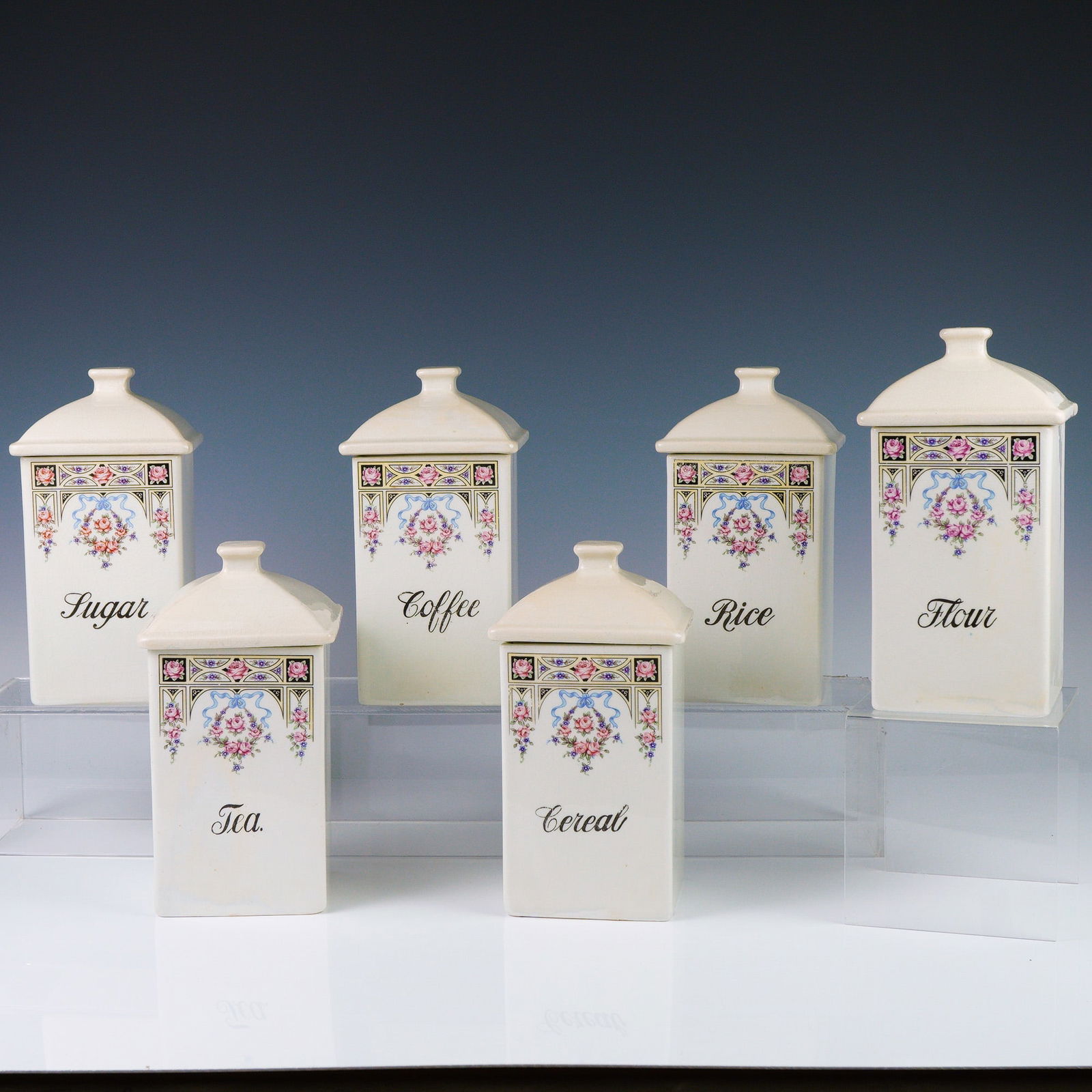 Ceramic Kitchen Canisters, Hand-Painted Floral Motif, Labeled: This charming set of six vintage ceramic kitchen canisters features beautifully hand-painted floral and geometric Art Deco-inspired borders, each elegantly labeled in black script for easy identificat
