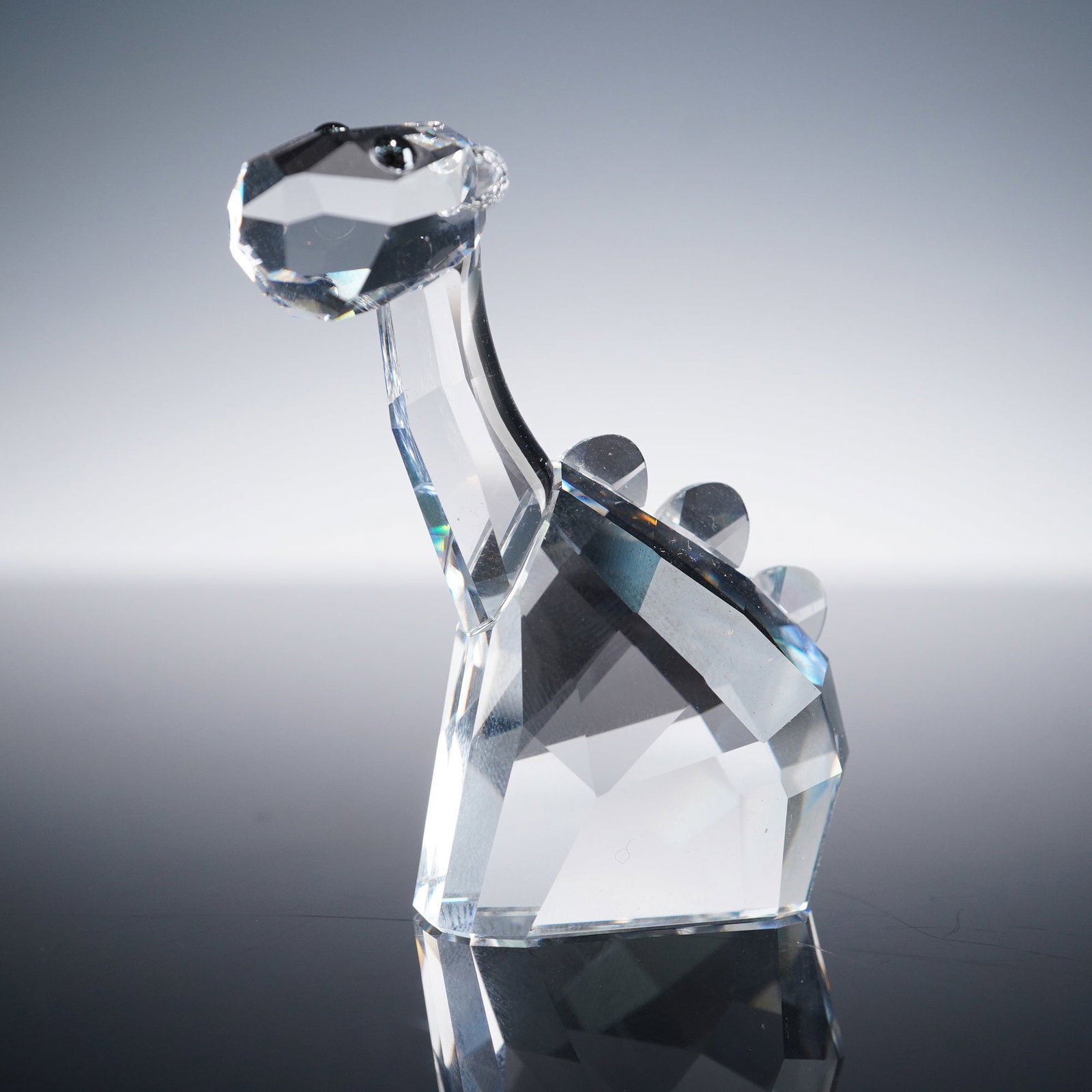 Swarovski Lovlots Pioneers Crystal Figurine, Jay D Dino: This charming collectible features a whimsical dinosaur crafted in precision-cut clear crystal with faceted detailing and jet-black crystal eyes. Part of Swarovski's Lovlots Pioneers collection, the f