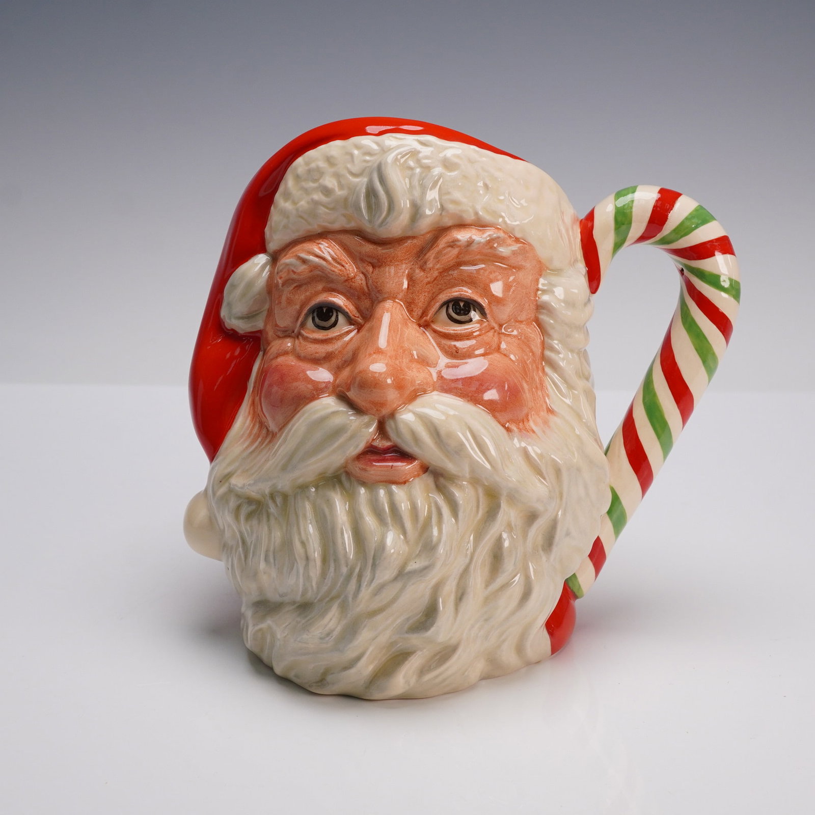 Royal Doulton Character Jug, Santa Claus D6840 Limited Edition: Royal Doulton character jug D6840, Santa Claus, modeled by Michael Abberley. Issued in 1989 as a special edition for the American Collectors Society, limited to 1000 pieces. Features a festive candy c