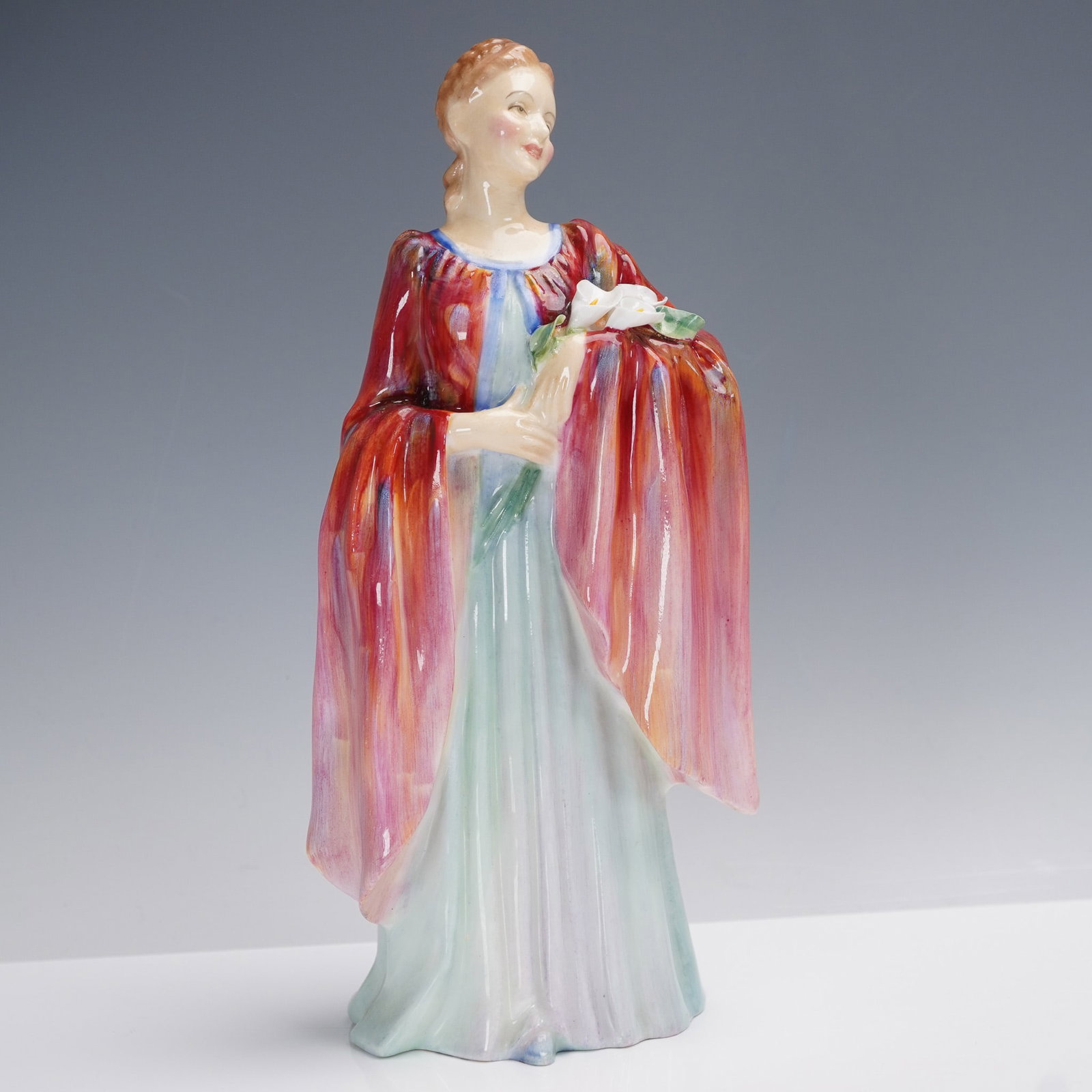 Royal Doulton Porcelain Figurine, Olivia HN1995: First issued in 1946, Olivia (HN1995) is a graceful Royal Doulton bone china figurine representing serene beauty in soft pastels and expressive detail. This charming piece depicts a poised young woman