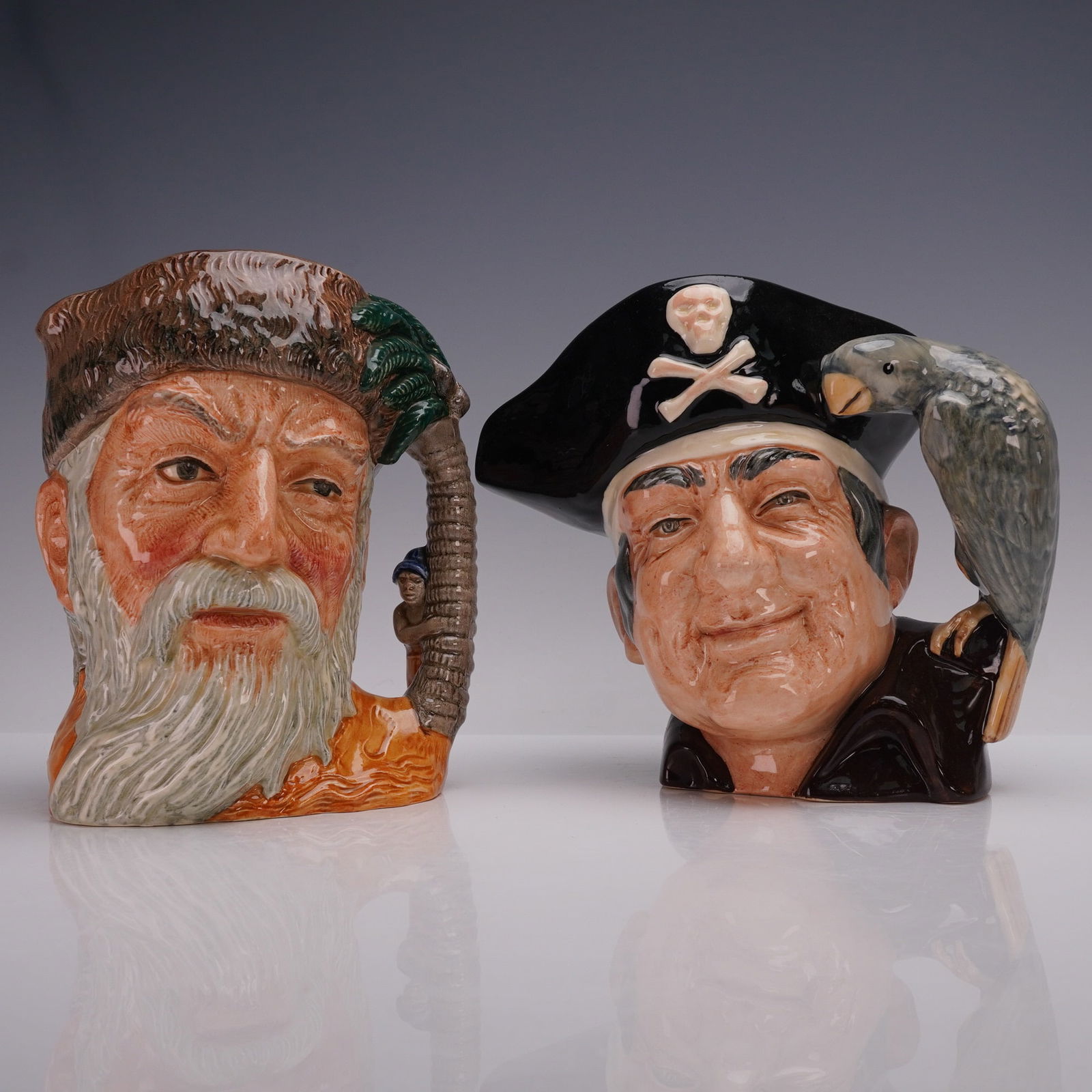 2pc Royal Doulton LG Character Jugs- Robinson Crusoe D6532 & D6335: A pair of Royal Doulton large character jugs featuring two of literature's most enduring adventurers, Robinson Crusoe D6532 and Long John Silver D6335. Robinson Crusoe, designed by David B. Biggs and