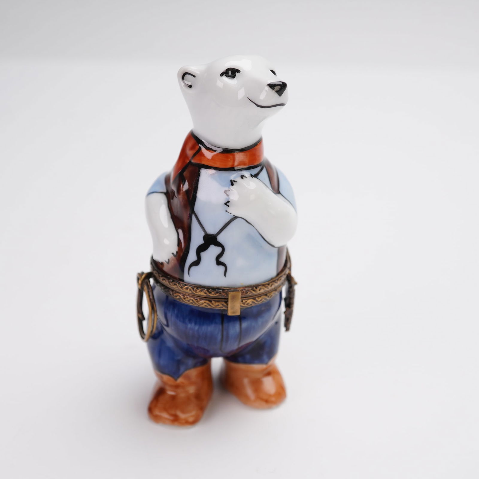 GR Limoges France Cowboy Polar Bear Treasure Box: Porcelain hinged trinket box in the form of a polar bear dressed as a cowboy. The figure is hand-painted with detailed features including a red scarf, light blue shirt, brown boots, and deep blue pant