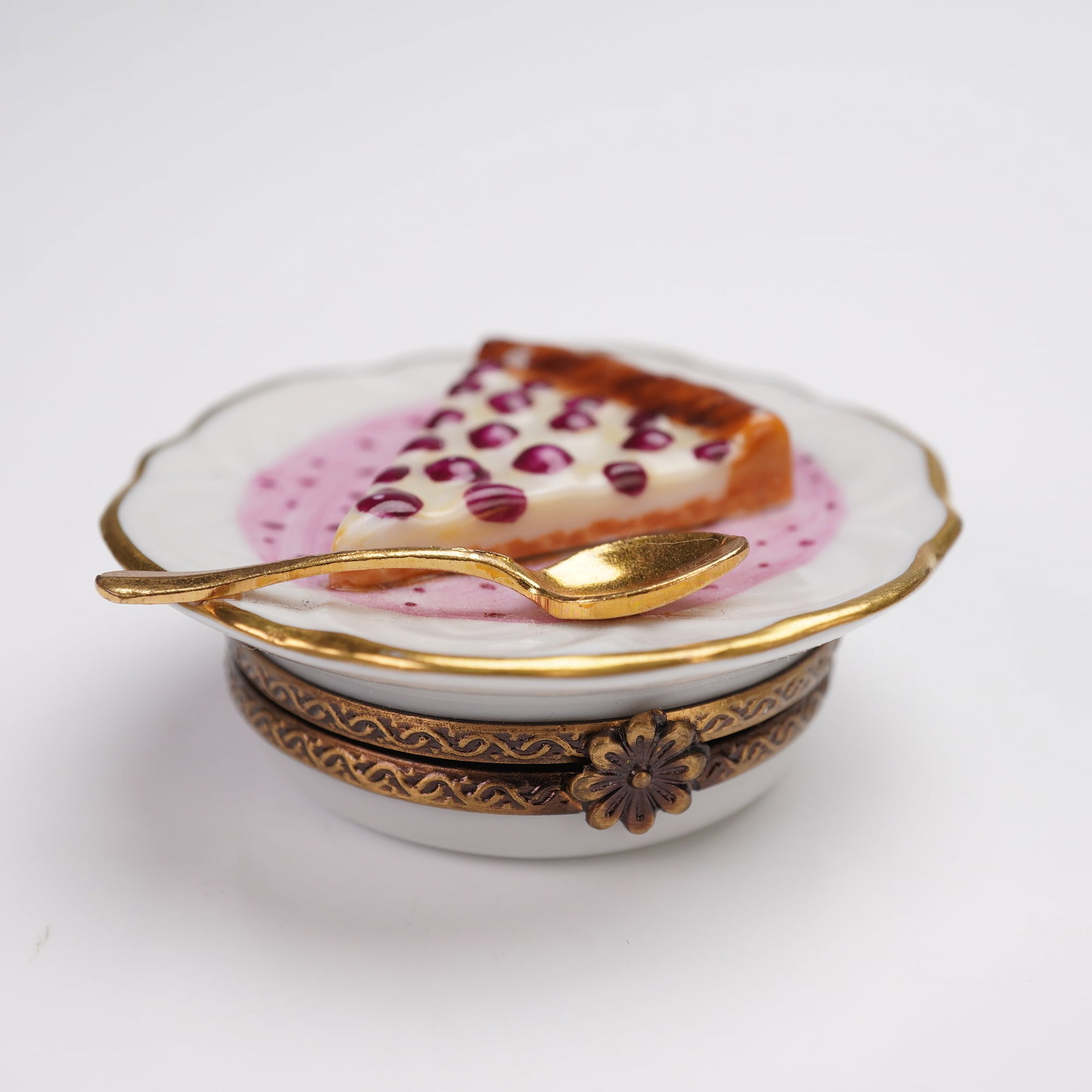 Parry Vieille Limoges Porcelain Treasure Box, Cherry Pie Delight: Hand-painted porcelain treasure box presenting a slice of cherry pie beside a gold-tone spoon on a scalloped plate with matching gold-tone rim. Floral detail hinge reveals a cherry motif on the interi