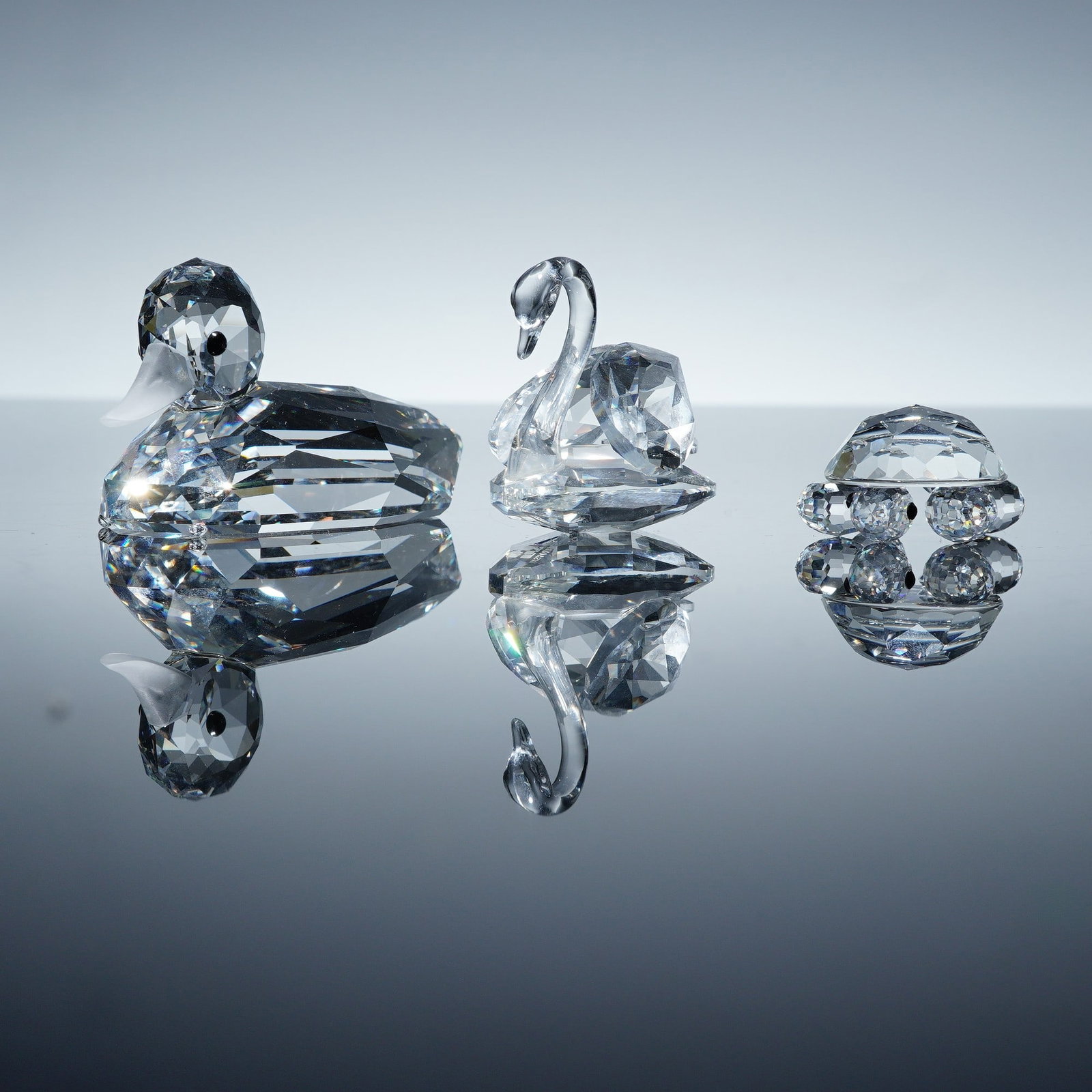 3pc Swarovski Max Schreck Crystal Figurines: This charming group includes the Mallard Duck, model 012723, crafted with a faceted body and smooth frosted beak; the Medium Swan, model 010006, designed with graceful lines and elegant detailing on t
