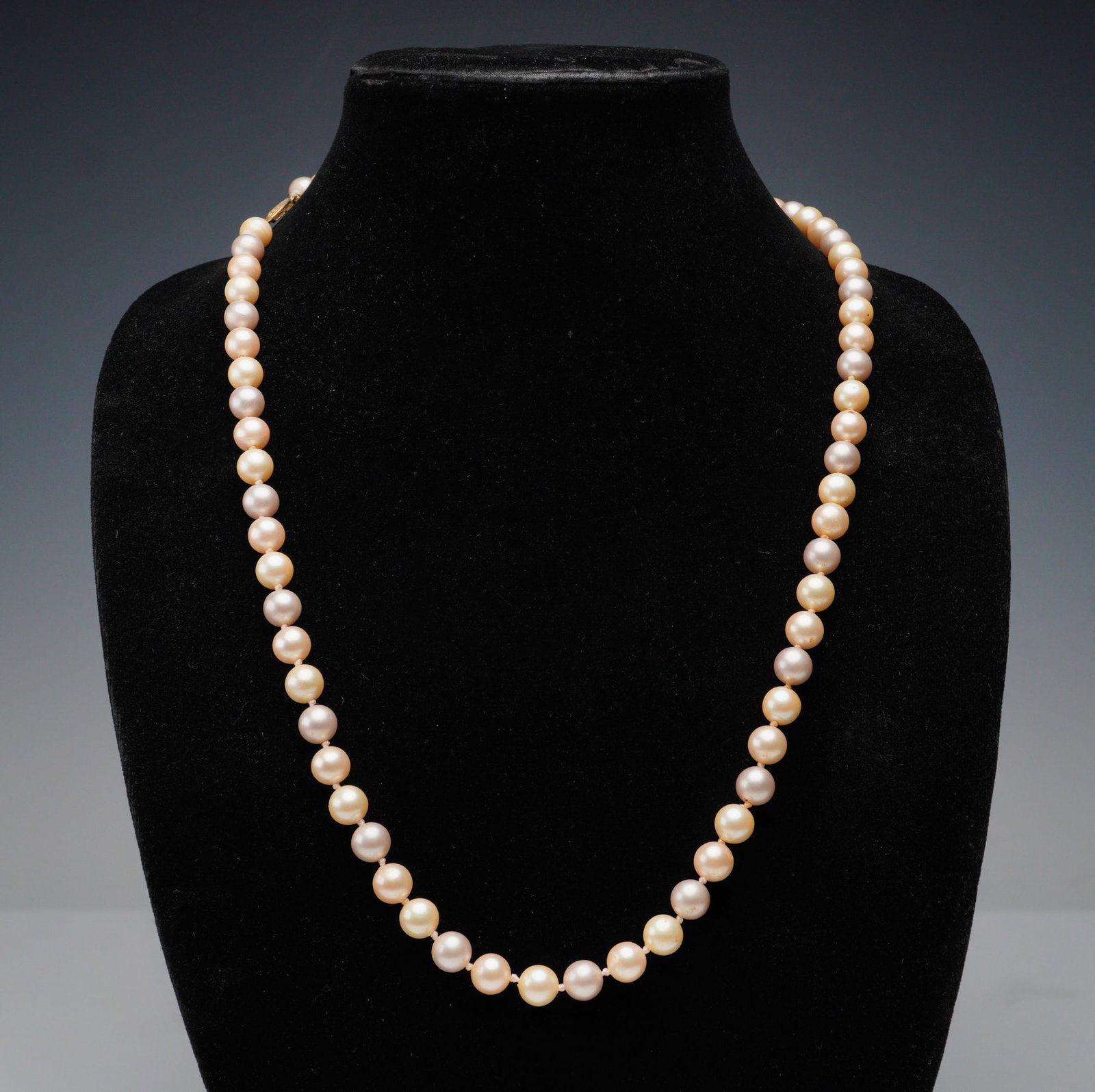 Simulated Hand Knotted Pearl Necklace: A graceful single strand of simulated pearls, this necklace presents a classic design with softly lustrous beads. Each pearl is individually hand knotted, enhancing both durability and elegance. Finis
