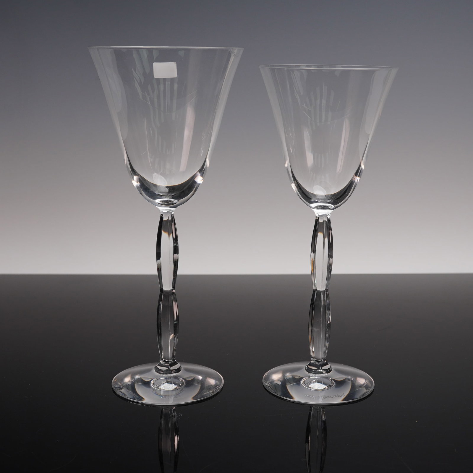 2pc Baccarat Crystal Wine Glasses, Onde Pattern, 2 Sizes: This 2-piece set of Baccarat wine glasses features the elegant Onde pattern, with two different sizes in the same design. Both glasses showcase Baccarat's renowned craftsmanship, with smooth, curved s