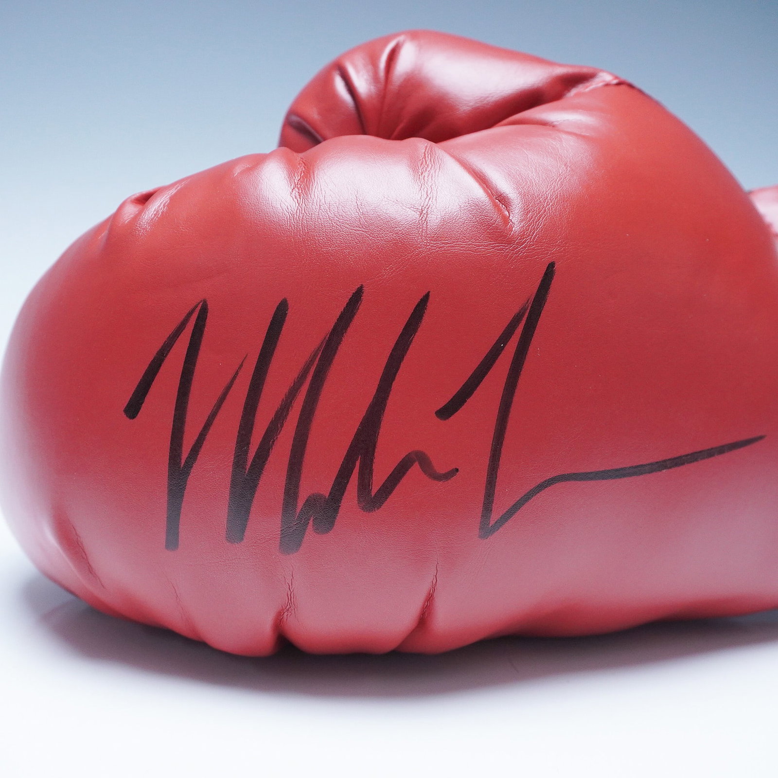Everlast Boxing Glove, Signed by Mike Tyson: Presented is a red Everlast boxing glove, personally signed by former heavyweight boxing champion Mike Tyson. This high-quality professional-style glove features black laces, reinforced stitching, and