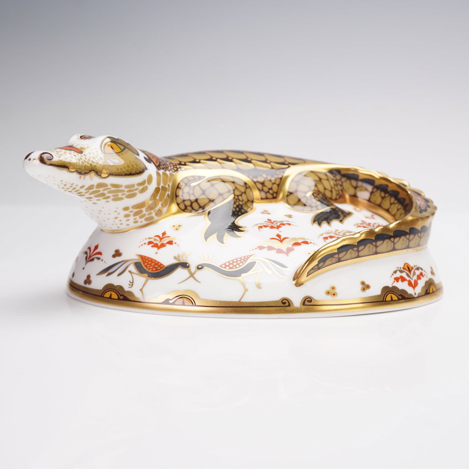 Royal Crown Derby Bone China Paperweight, Crocodile: In the form of a crocodile, produced as a Gold Signature Edition commissioned by The Guild of Specialist China and Glass Retailers. This piece features detailed gilded and hand-painted decoration with