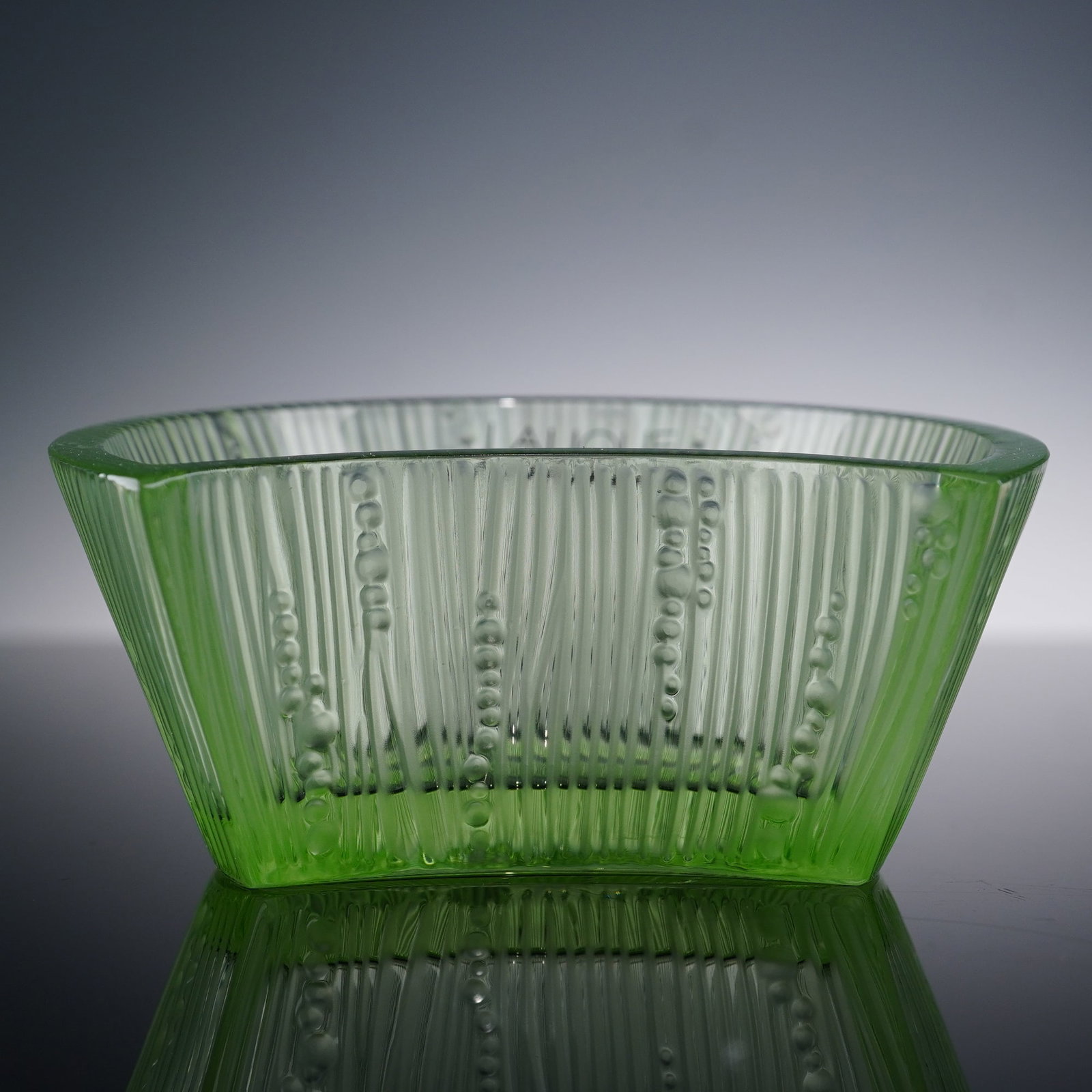 Lalique Crystal Green Bowl, Luna: Attractive crystal green bowl in a delicate green hue, intricately formed with vertical ribbing interspersed with raised dot motifs. Lalique sticker label. Lalique backstamp. This item has its origina