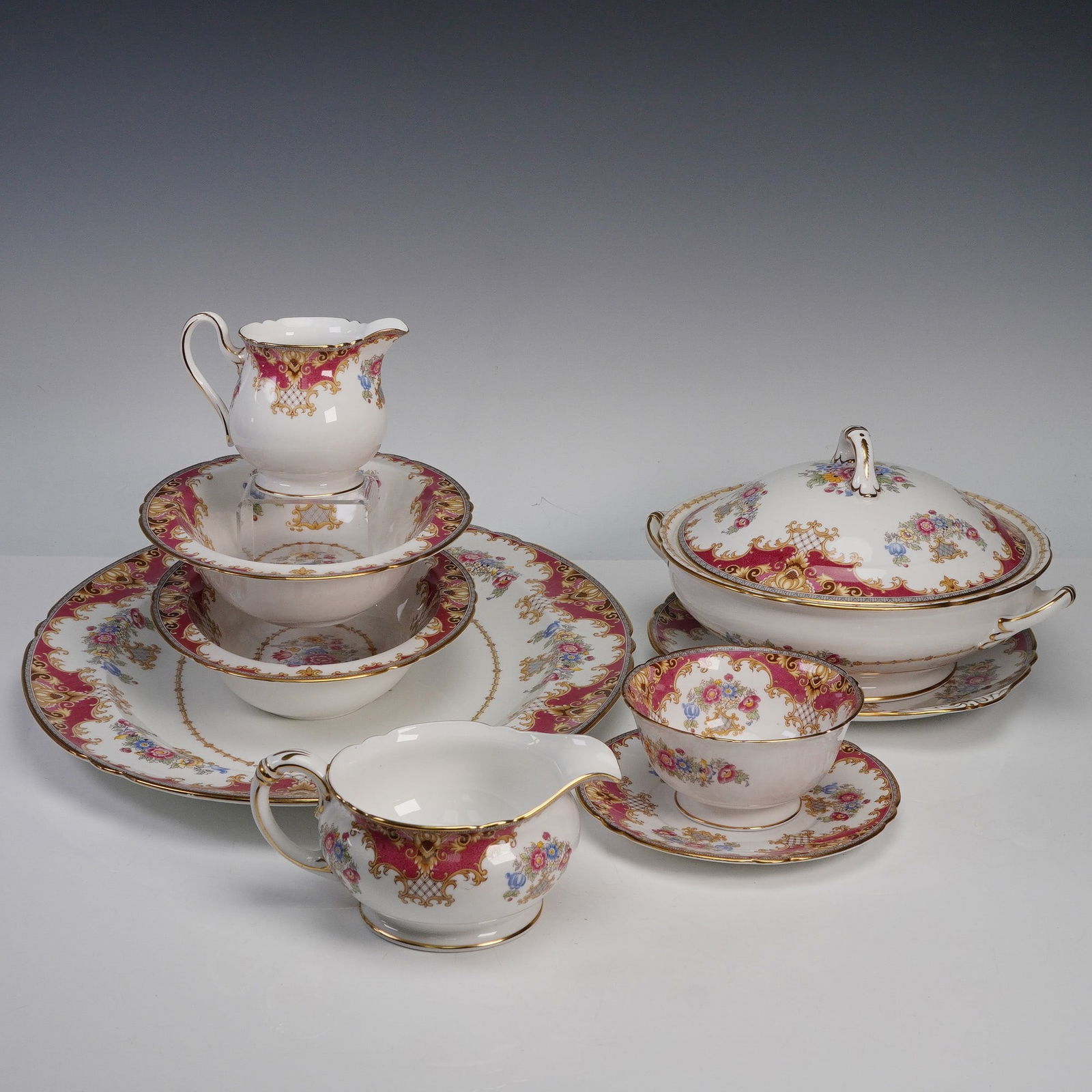 10pc Shelley Fine Bone China Sheraton Pink Dinnerware Set: An eye-catching Shelley Fine Bone China set in the Sheraton Pink pattern, featuring deep rose borders richly decorated with raised gilt scrollwork, lattice accents, and colorful floral bouquets in the