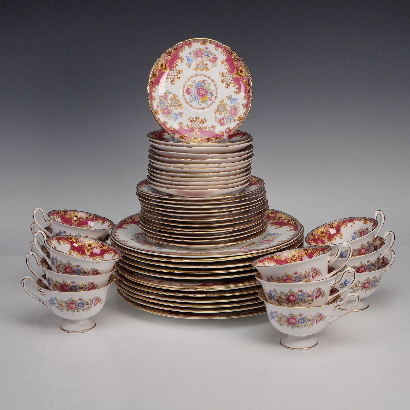 48pc Shelley Fine Bone China Sheraton Pink Dinnerware Set: This is a set for twelve which consists of a total of 48 pieces, including 12 cups, 12 saucers, 12 dessert plates, and 12 dinner plates. The service is crafted in fine bone china and decorated in the