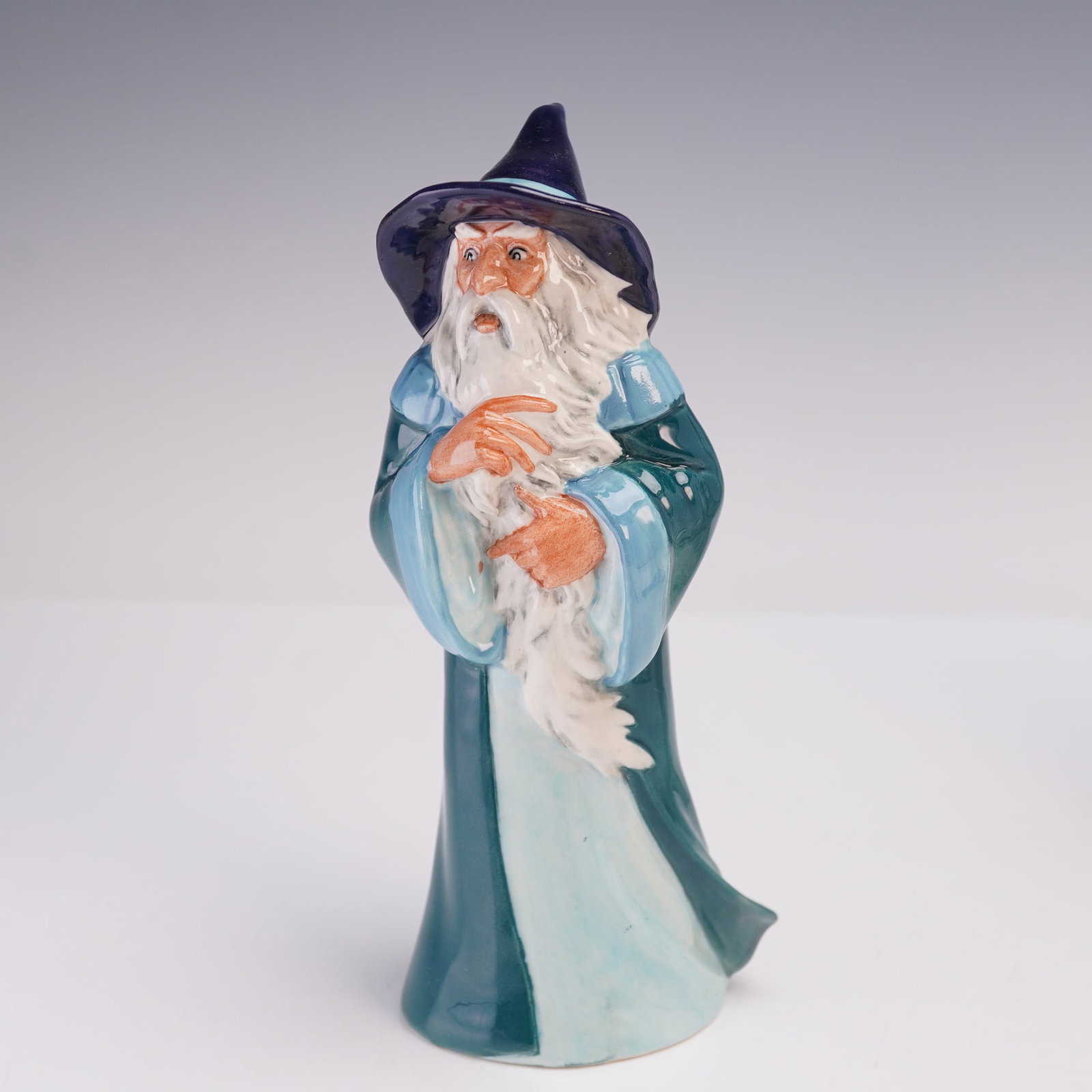 Royal Doulton Figurine, Gandalf HN2911: A porcelain figurine depicting Gandalf from J.R.R. Tolkien's The Lord of the Rings. Designed as part of the Middle Earth series and issued under license from Tolkien Enterprises in 1979. The hand-pain